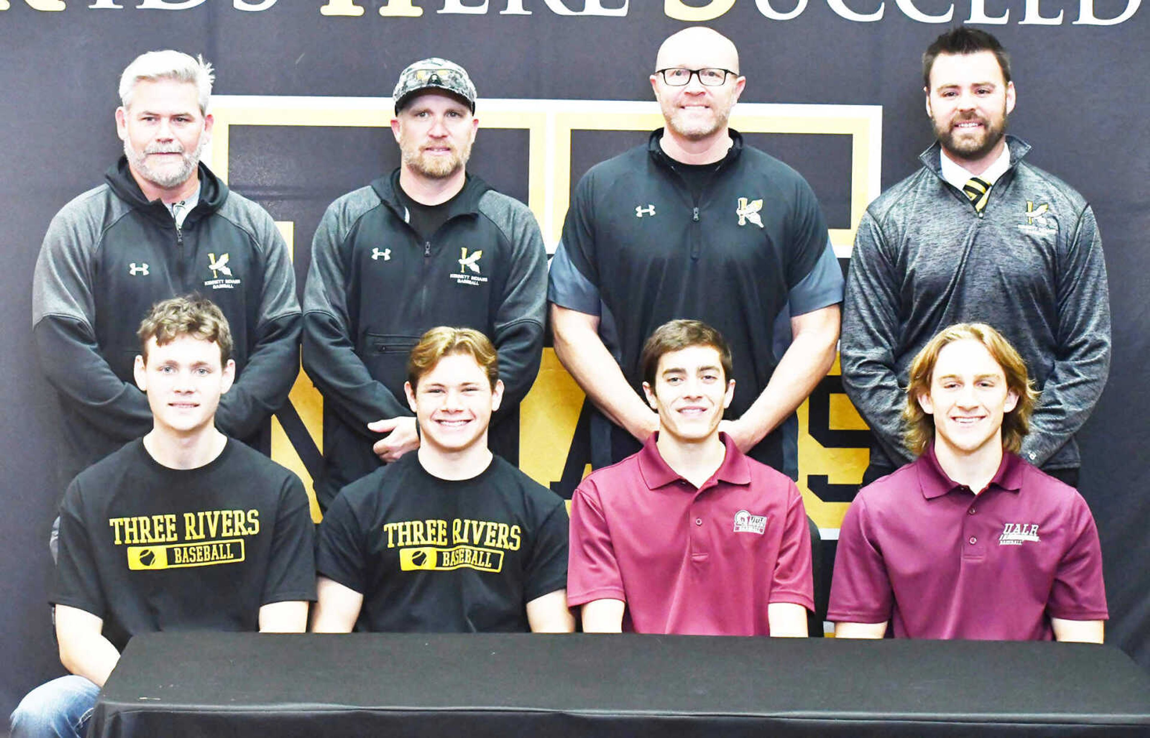 (Front row, from left) Baseball players Peyton Branum, J.C. Poole, Matt Gardner and Ashton Williams smile during their special signing ceremony in the Kennett High School library dated Wednesday, Nov. 15. Branum and Poole will play for Three Rivers College in Poplar Bluff next year, while Gardner and Williams head to Little Rock (Ark.). Also photographed are back row, from left, assistant coaches Aaron Pixley and Ronnie Lewallen, head coach Aaron New and Lance Penn.