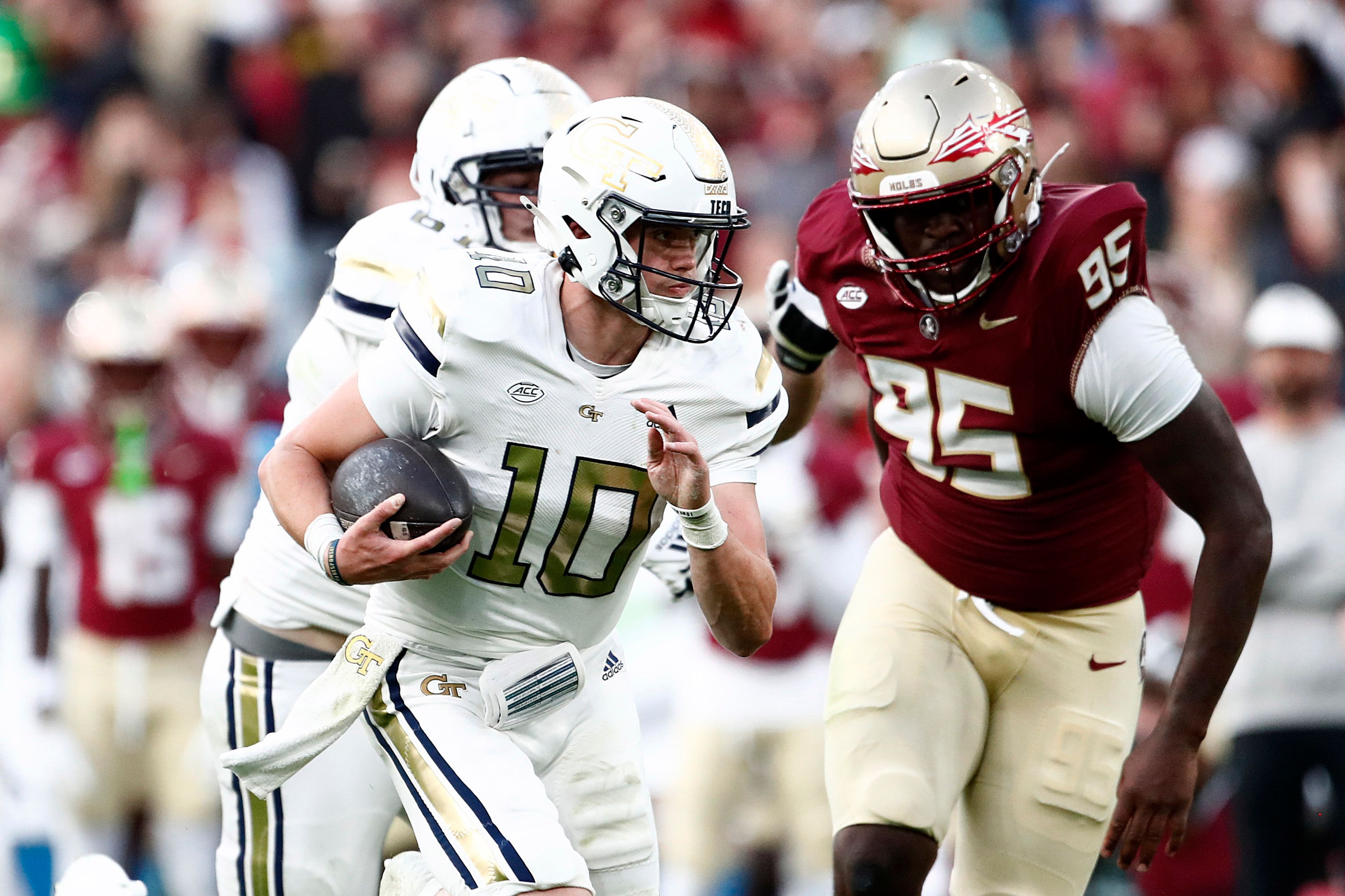 Georgia Tech's Haynes King, left, and Florida State's Daniel Lyons challenge for the ball during the NCAA college football game between Georgia Tech and Florida State at the Aviva stadium in Dublin, Saturday, Aug. 24, 2024. (AP Photo/Peter Morrison)