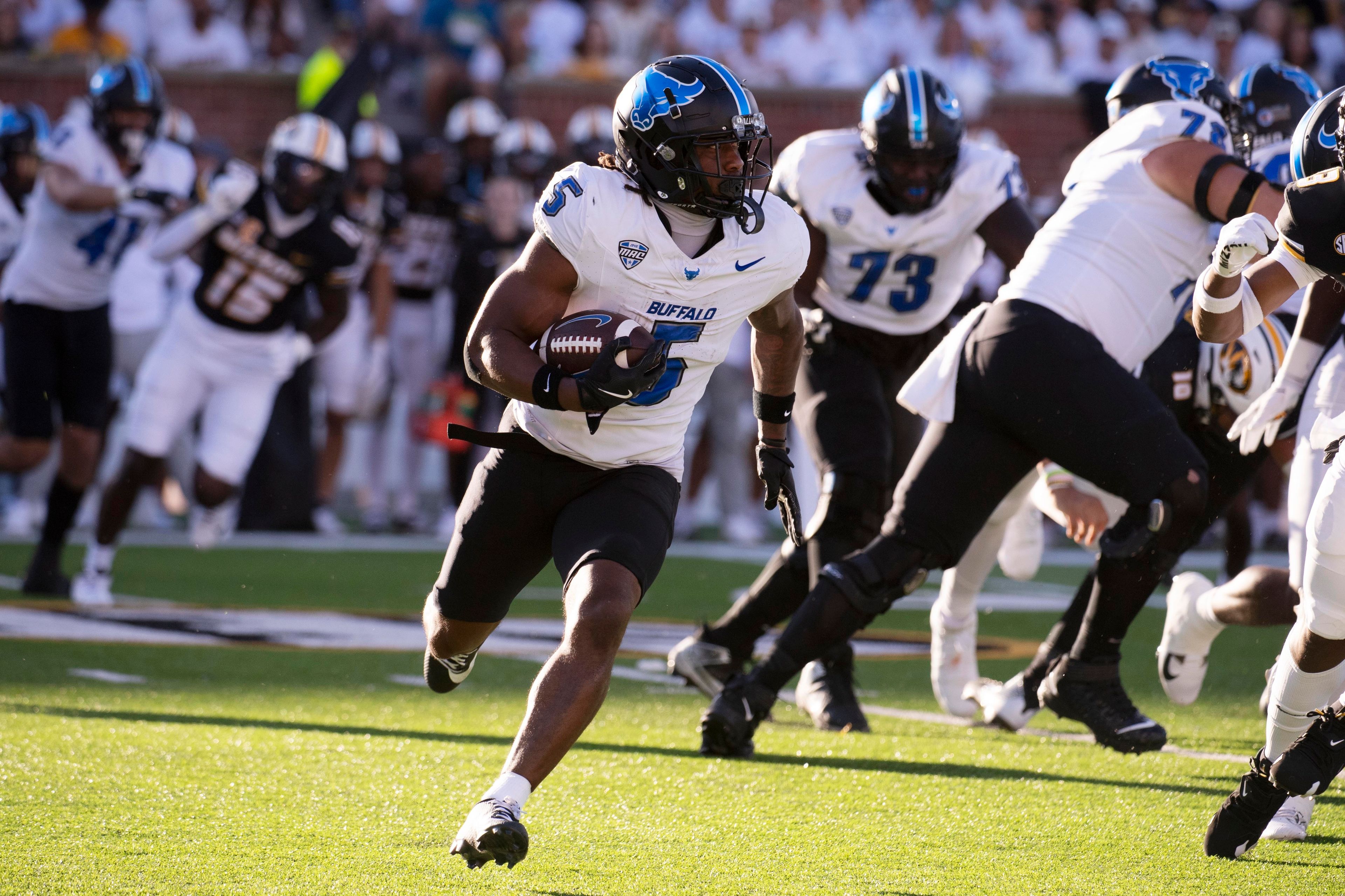 Buffalo running back Al-Jay Henderson, center, runs around Missouri defenders during the first half of an NCAA college football game Saturday, Sept. 7, 2024, in Columbia, Mo. (AP Photo/L.G. Patterson)