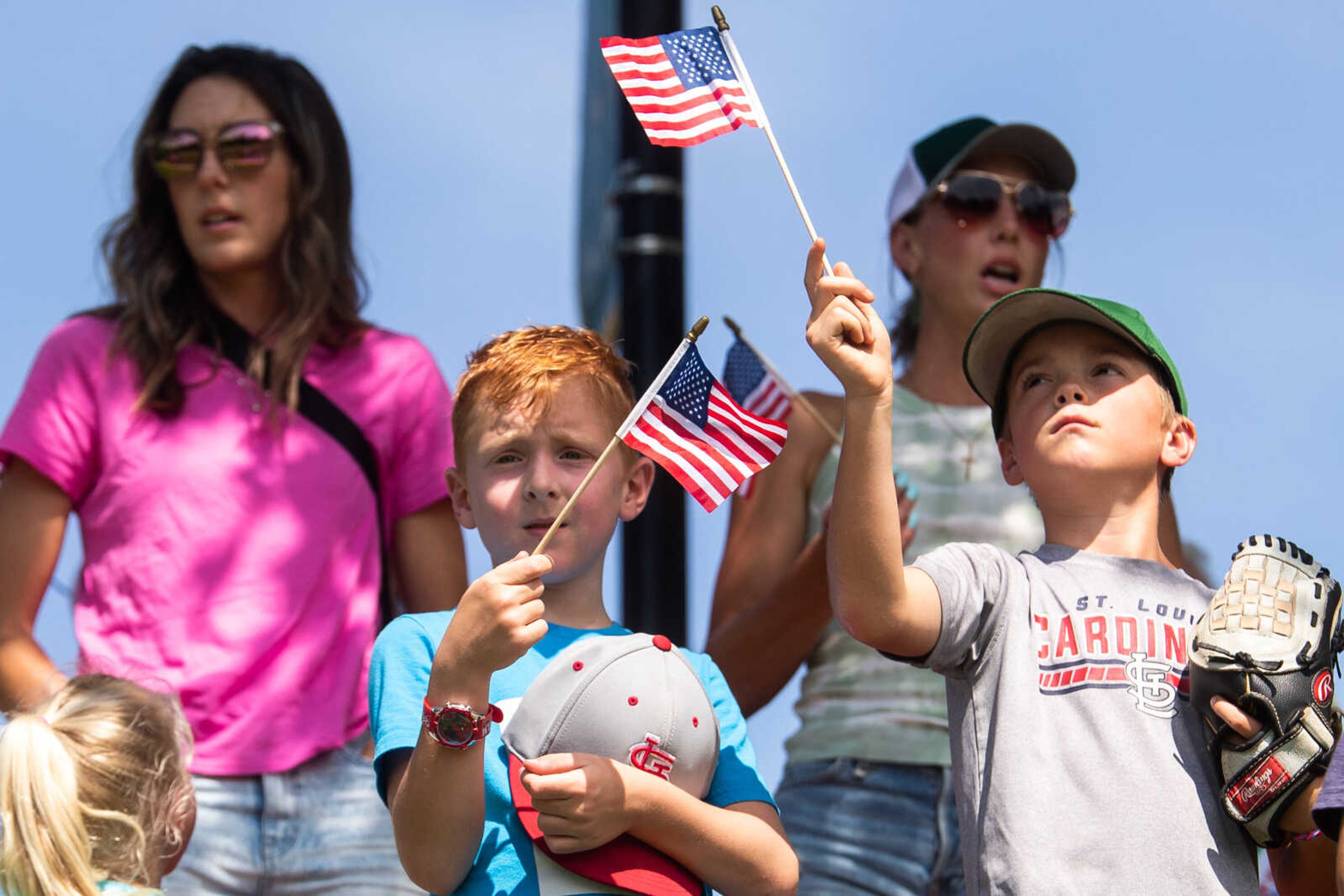 Cousins Greyson Busch, 7, and Myles Biri, 8, wave miniature American flags on Flag Day, Wednesday, June 14 at Capaha Field.