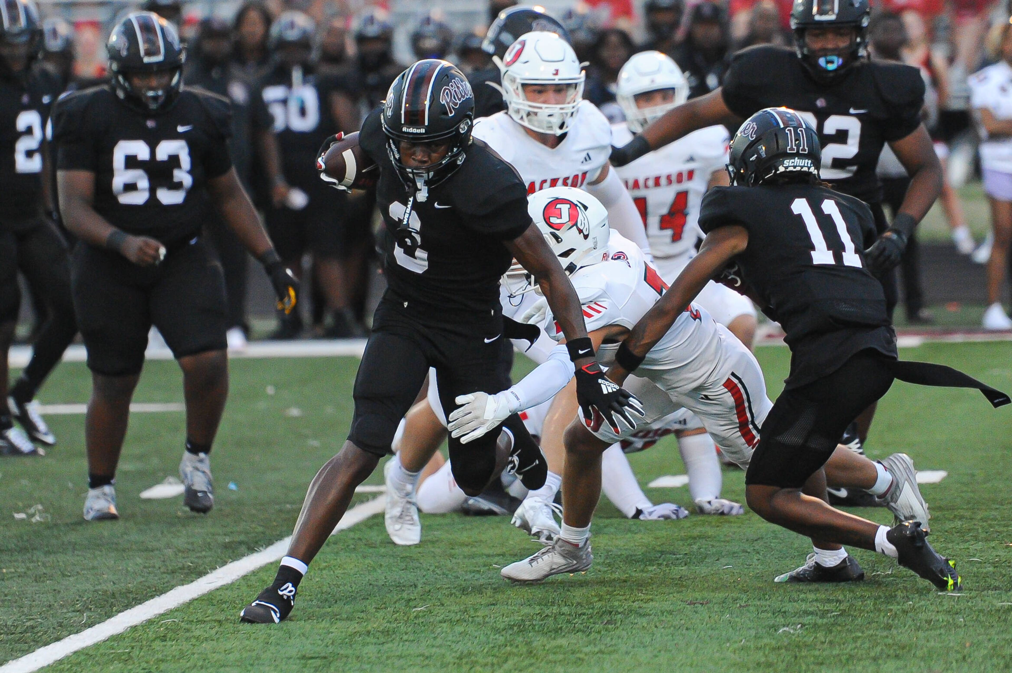 Cardinal Ritter's Jamarion Parker slips a tackle during a Friday, August 30, 2024 game between the Cardinal Ritter College Prep Lions and the Jackson Indians at Cardinal Ritter College Prep High School in St. Louis. Cardinal Ritter defeated Jackson, 44-7.