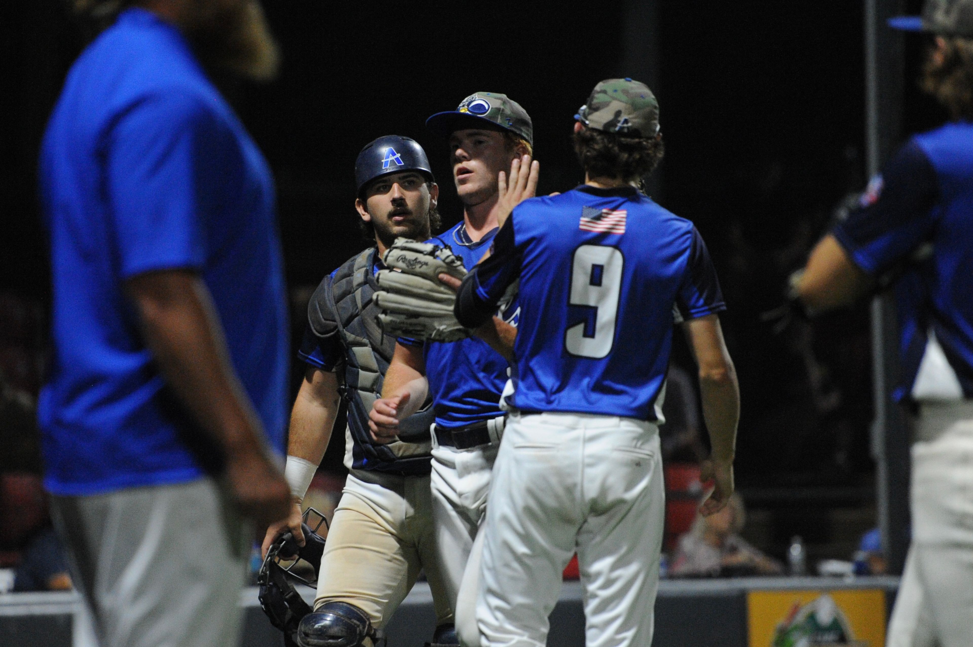 Aycorp's battery meets after the inning during a Saturday, August 10, 2024 Babe Ruth World Series game between the Aycorp Fighting Squirrels and Manassas, Virginia, at Capaha Field in Cape Girardeau, Mo. Aycorp defeated Manassas, 3-1.