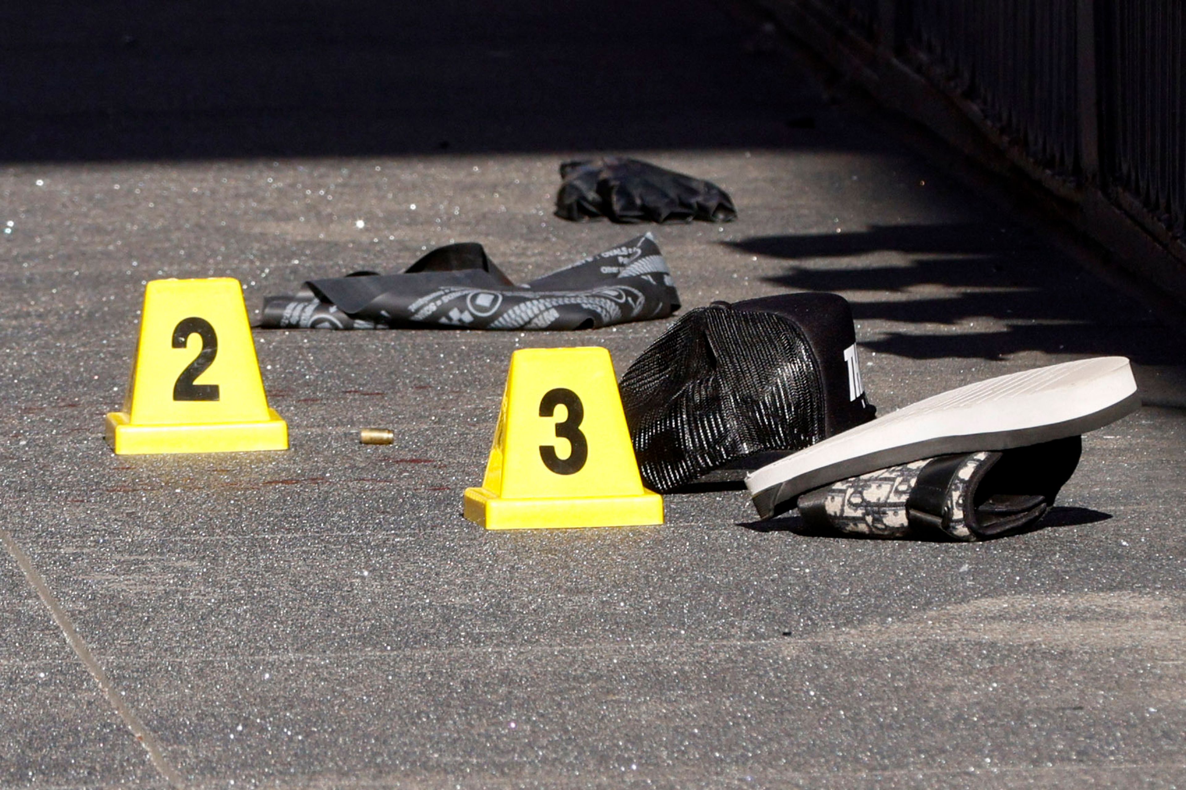 Blood and a shell casing is seen tagged as evidence as police officers secure the area and investigate the scene of a shooting at Union Square in San Francisco, Saturday, Aug. 31, 2024. San Francisco 49ers wide receiver Ricky Pearsall was shot Saturday during an attempted robbery, the city's mayor said. (Santiago Mejia/San Francisco Chronicle via AP)