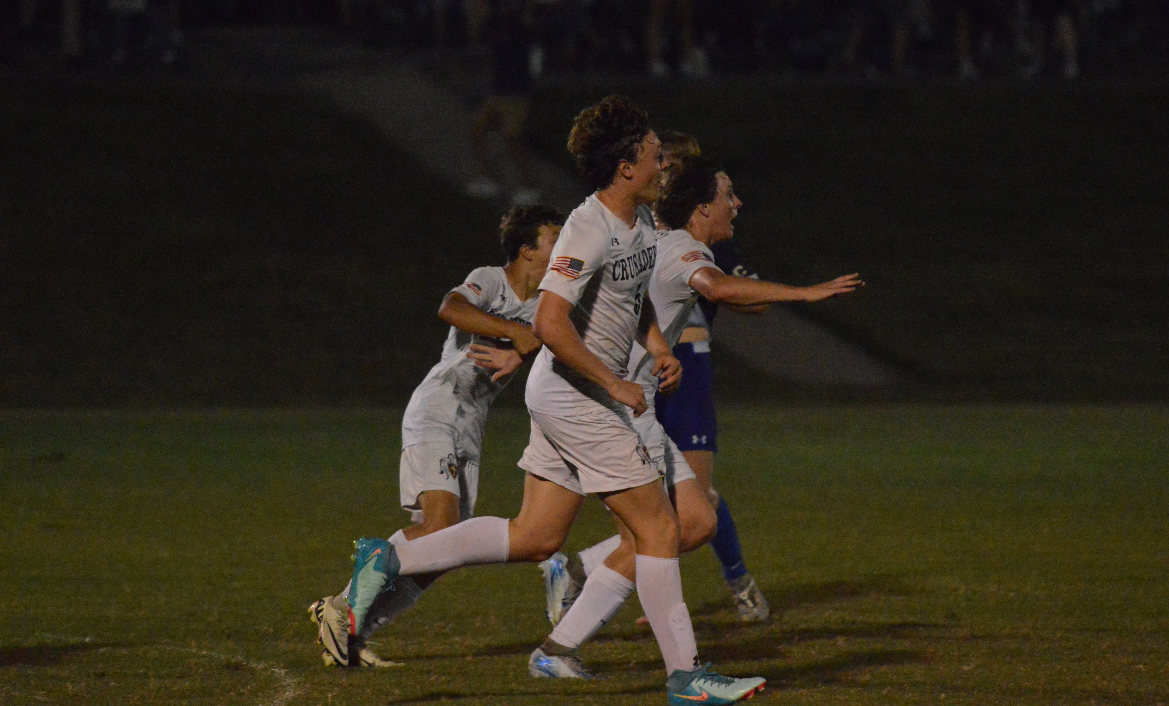 The Saxony Lutheran boys' soccer team celebrates moments after junior Maksim Mayhew scores the go-ahead goal with 21 seconds remaining against Notre Dame on Tuesday, Sept. 17.