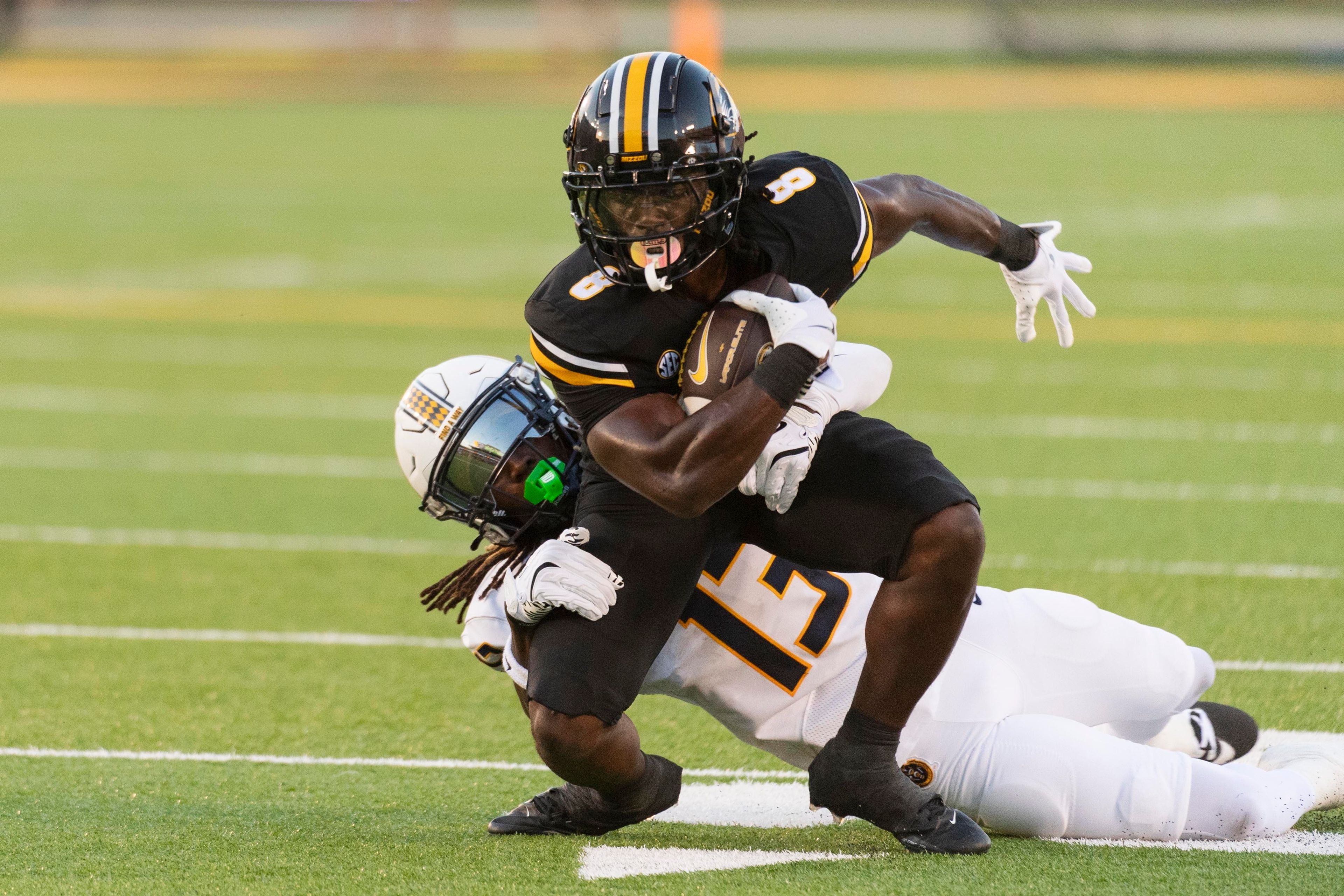 Missouri running back Nate Noel (8) runs through Murray State defensive back KaVan Reed (13) during the first quarter of an NCAA college football game Thursday, Aug. 29, 2024, in Columbia, Mo. (AP Photo/L.G. Patterson)