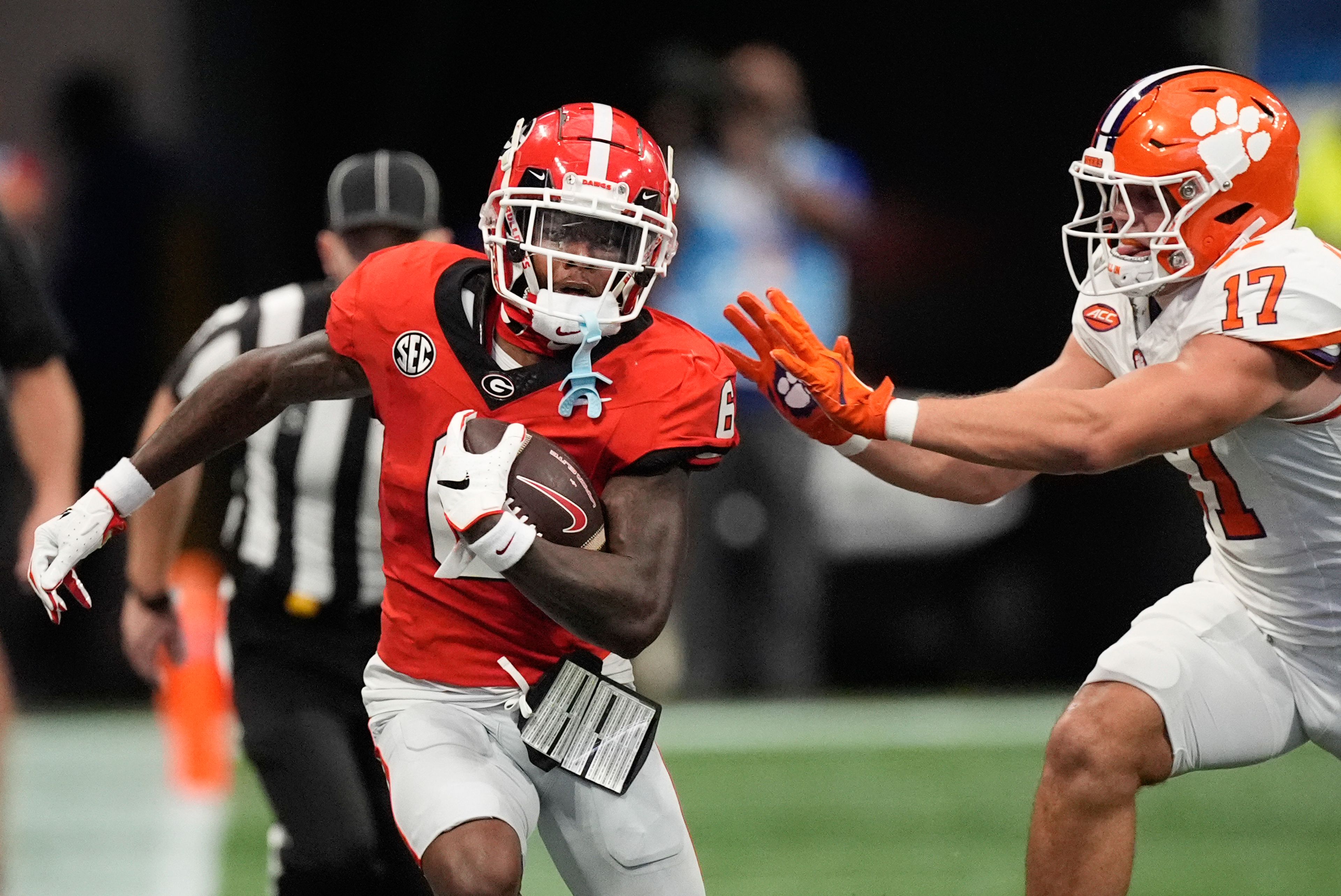 Georgia wide receiver Dominic Lovett (6) is pushed out of bounds by Clemson linebacker Wade Woodaz (17) during the first half of an NCAA college football game Aug. 31, 2024, in Atlanta. (AP Photo/John Bazemore)