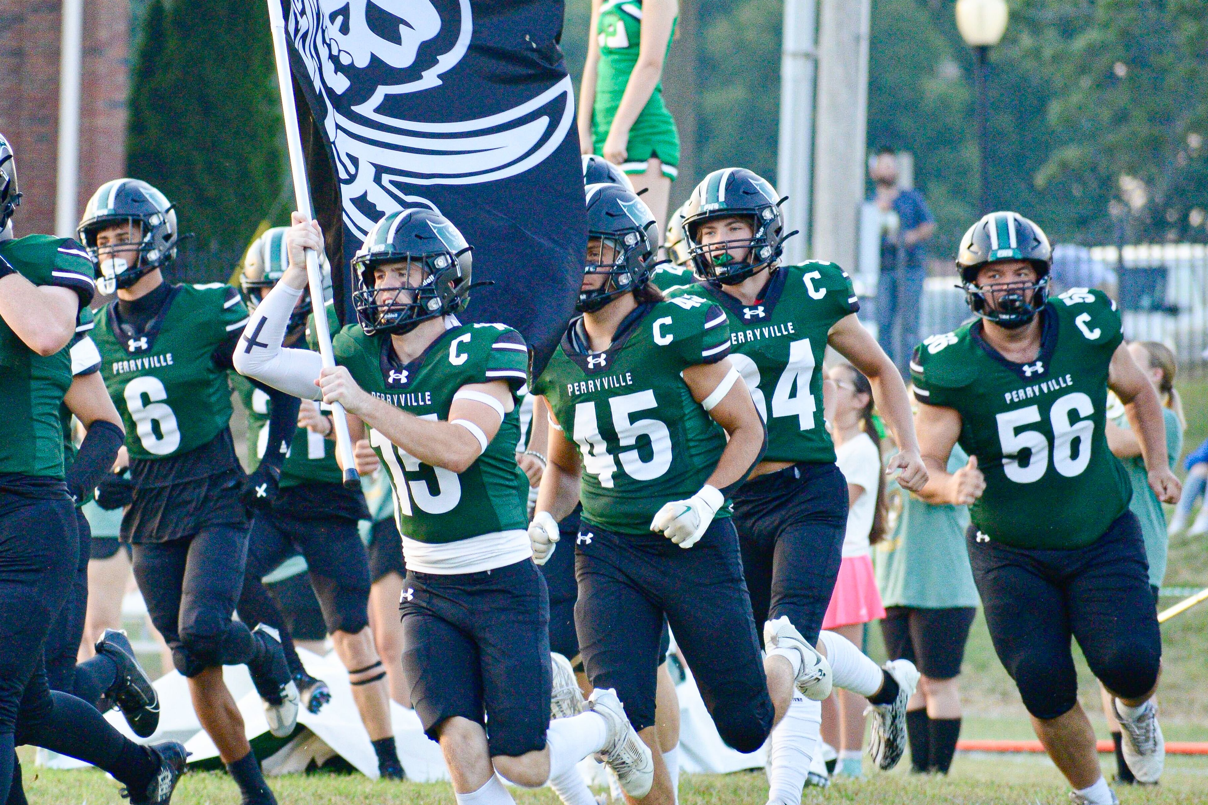 Perryville receiver Cole Lane carries the Pirate flag upon the team's entrance on the field before a game against Fredericktown on Thursday, Aug. 29, in Perryville, Mo.