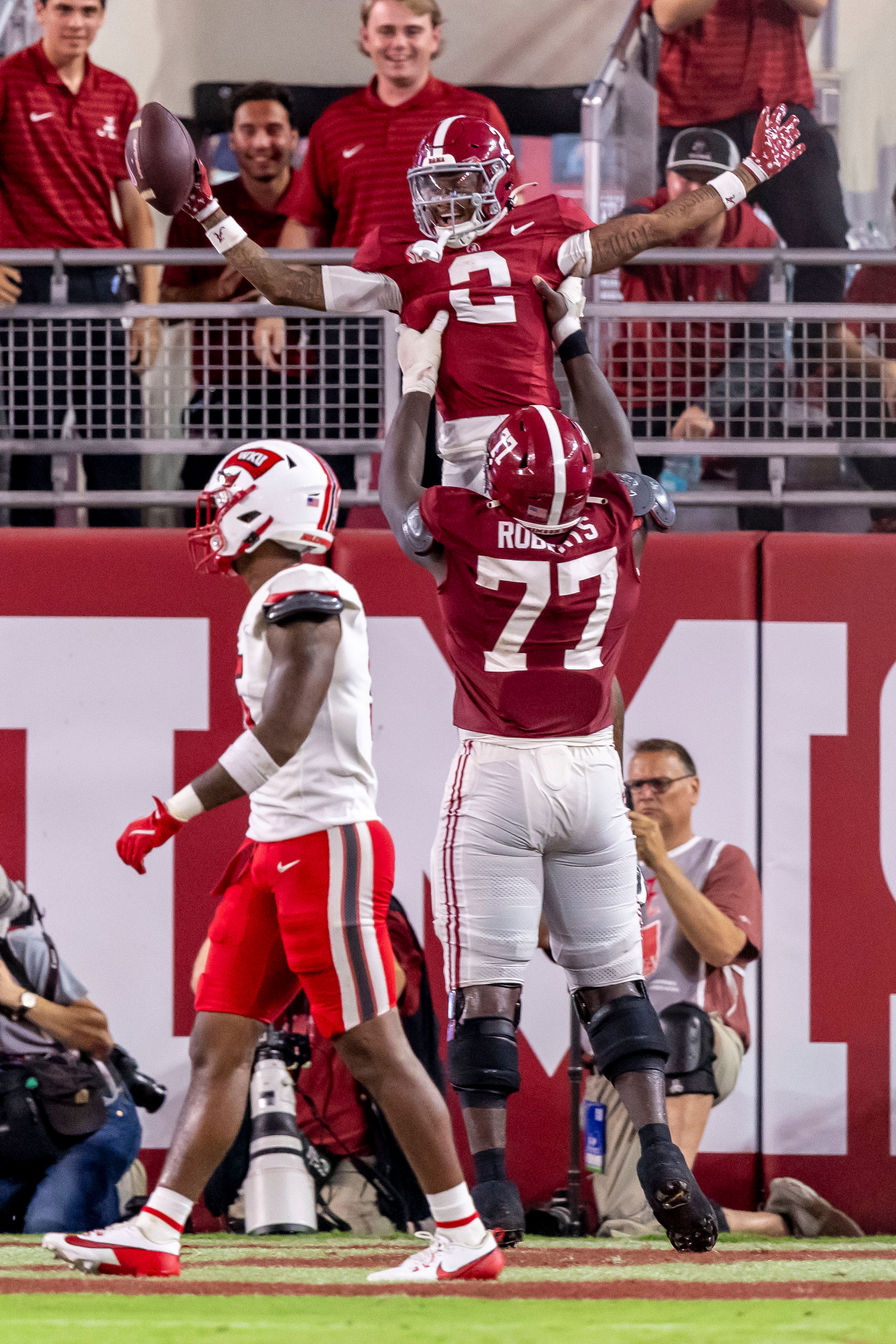 Alabama wide receiver Ryan Williams (2) celebrates a 55-yard touchdown reception with offensive lineman Jaeden Roberts (77), during the first half of an NCAA college football game against Western Kentucky, Saturday, Aug. 31, 2024, in Tuscaloosa, Ala. Also pictured is Western Kentucky linebacker Kylan Guidry (5). (AP Photo/Vasha Hunt)