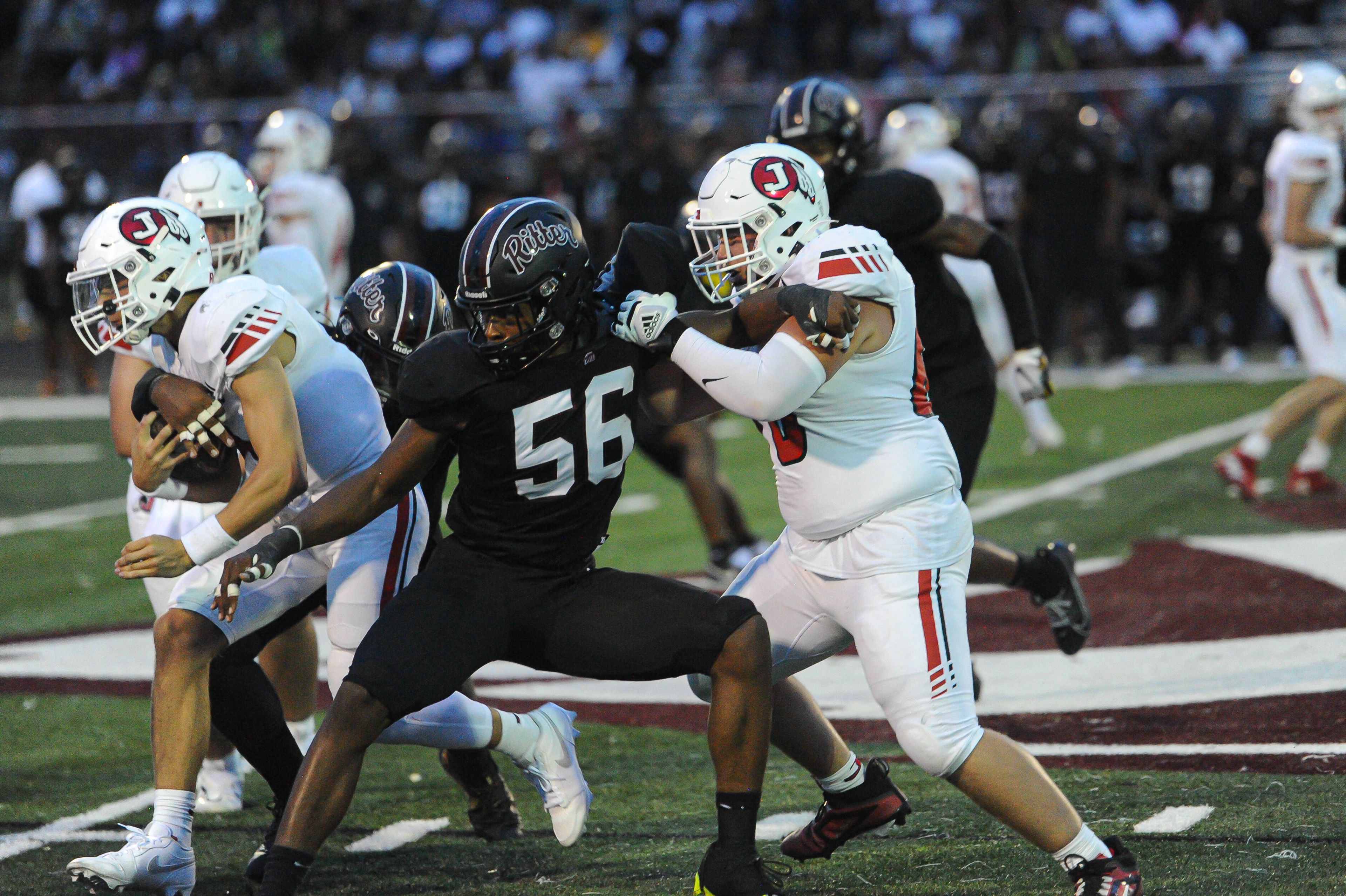 Jackson's Grant Lindsley fights to block during a Friday, August 30, 2024 game between the Cardinal Ritter College Prep Lions and the Jackson Indians at Cardinal Ritter College Prep High School in St. Louis. Cardinal Ritter defeated Jackson, 44-7.