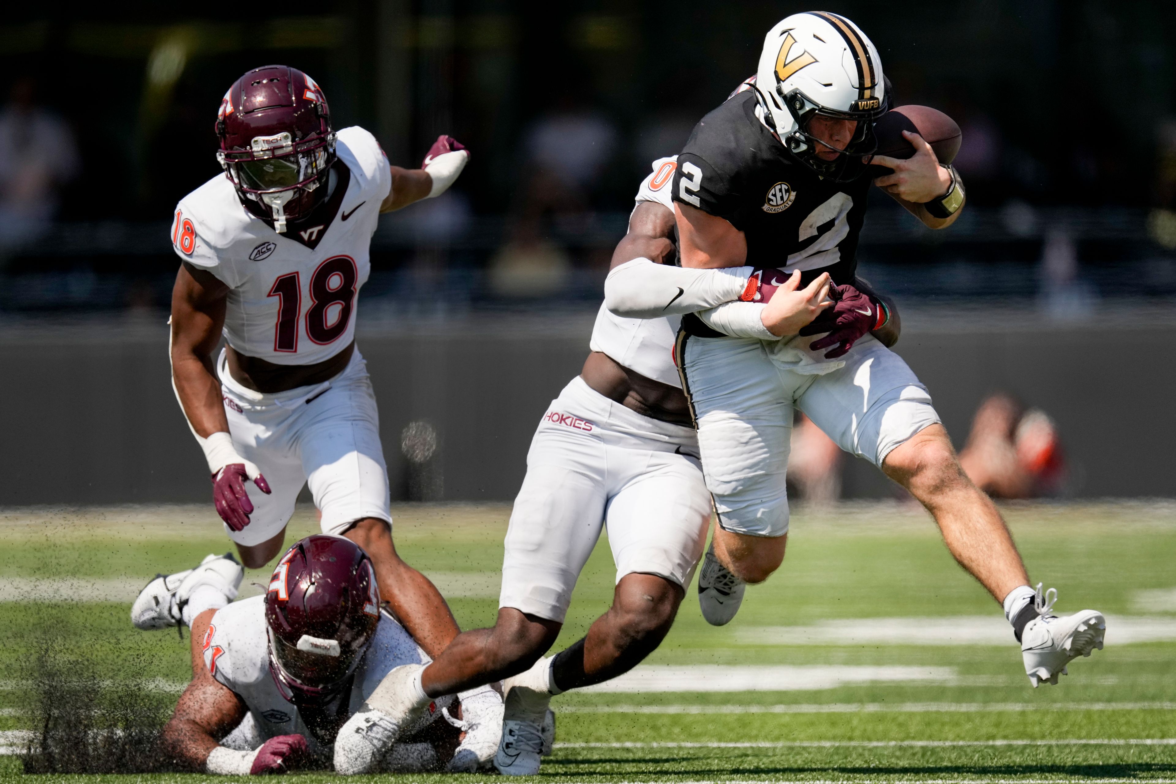 Vanderbilt quarterback Diego Pavia (2) is tackled by Virginia Tech linebacker Keli Lawson (0) during the second half of an NCAA college football game Saturday, Aug. 31, 2024, in Nashville, Tenn. (AP Photo/George Walker IV)