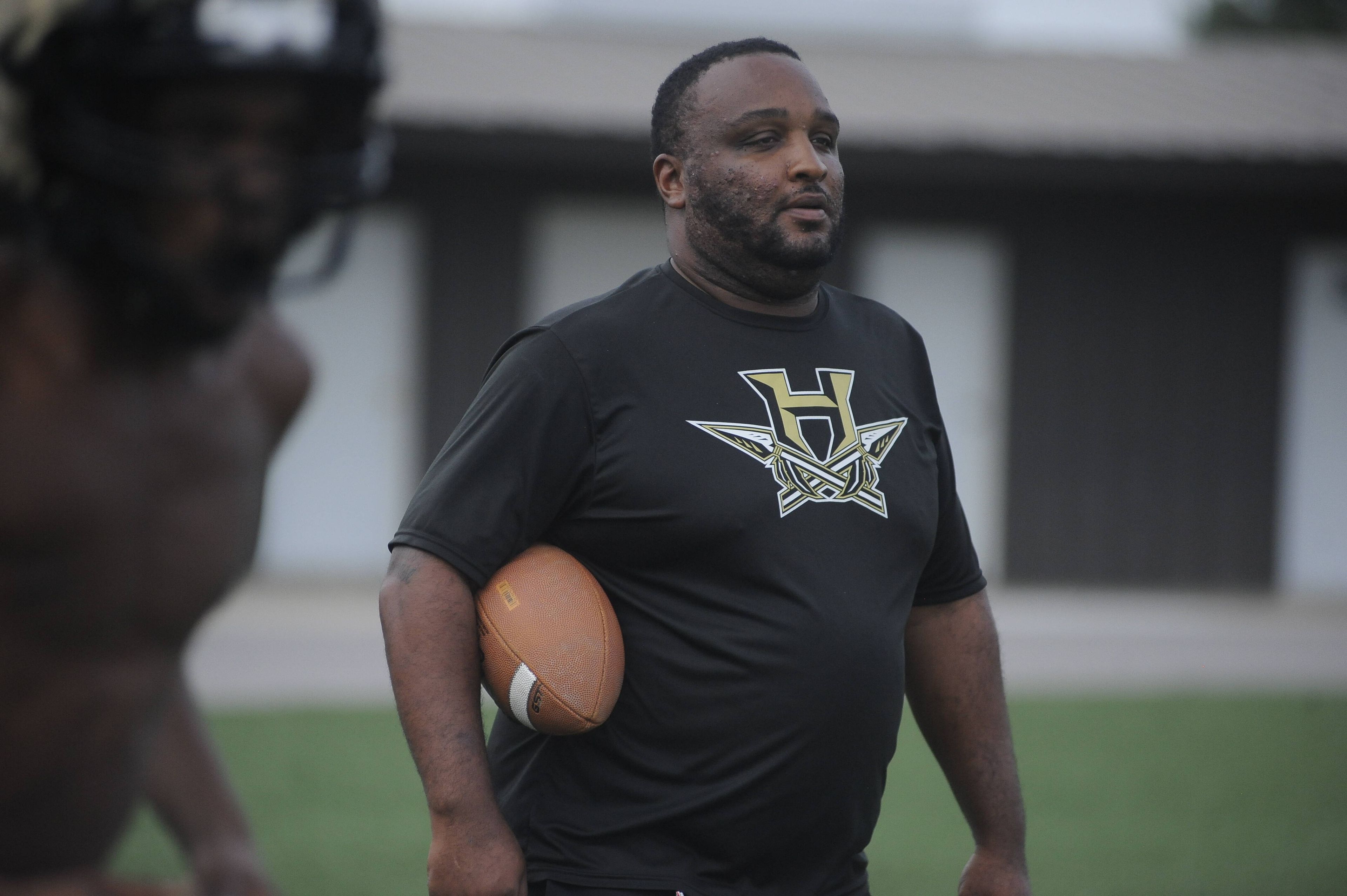 Hayti High School football coach Dominique Robinson watches his team practice earlier this season in training camp at the school.