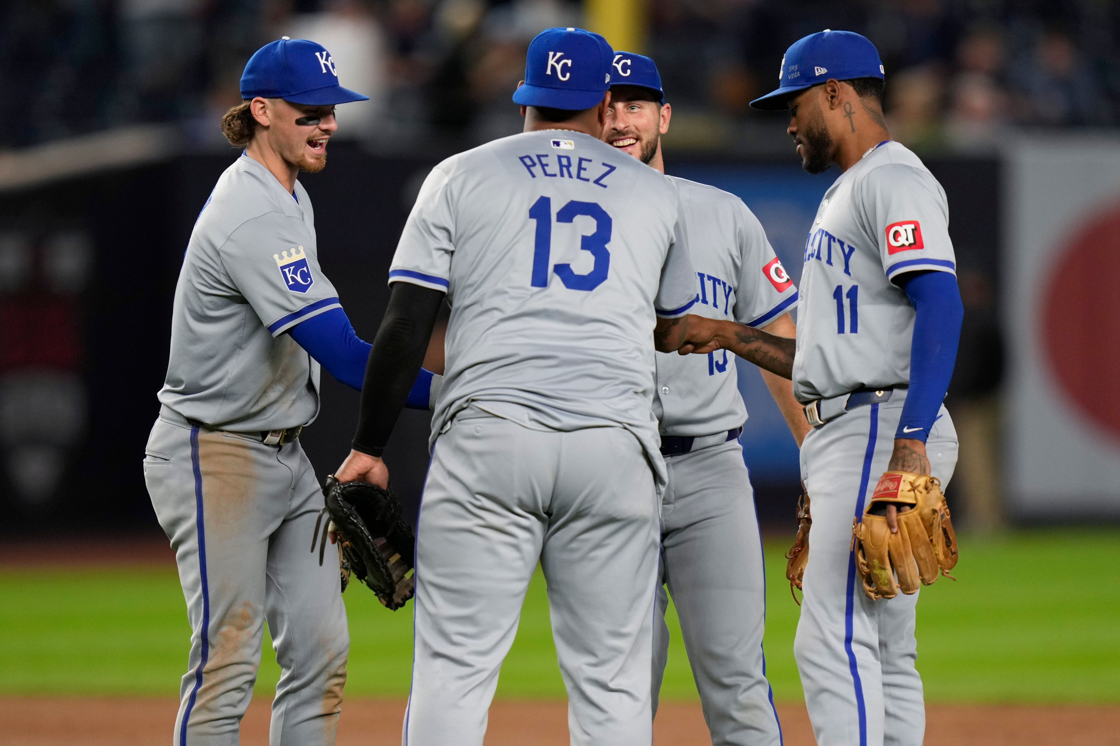 Kansas City Royals' Bobby Witt Jr., left, Salvador Perez (13), Paul DeJong, second from right, and Maikel Garcia (11) celebrate after a baseball game against the New York Yankees at Yankee Stadium, Tuesday, Sept. 10, 2024, in New York. (AP Photo/Seth Wenig)