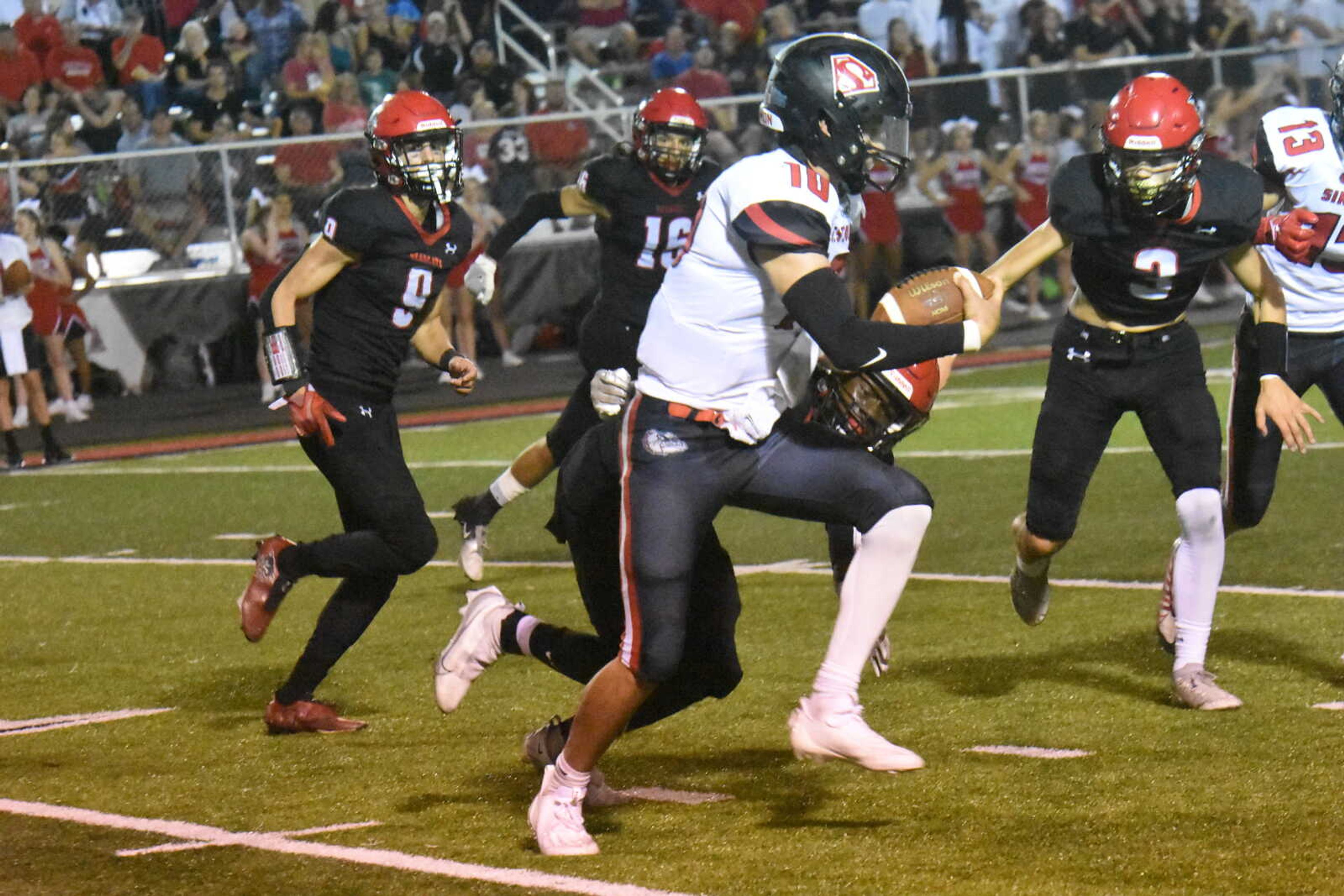 Sikeston quarterback Joseph Heckemeyer (10) looks to run up field against the Dexter defense.