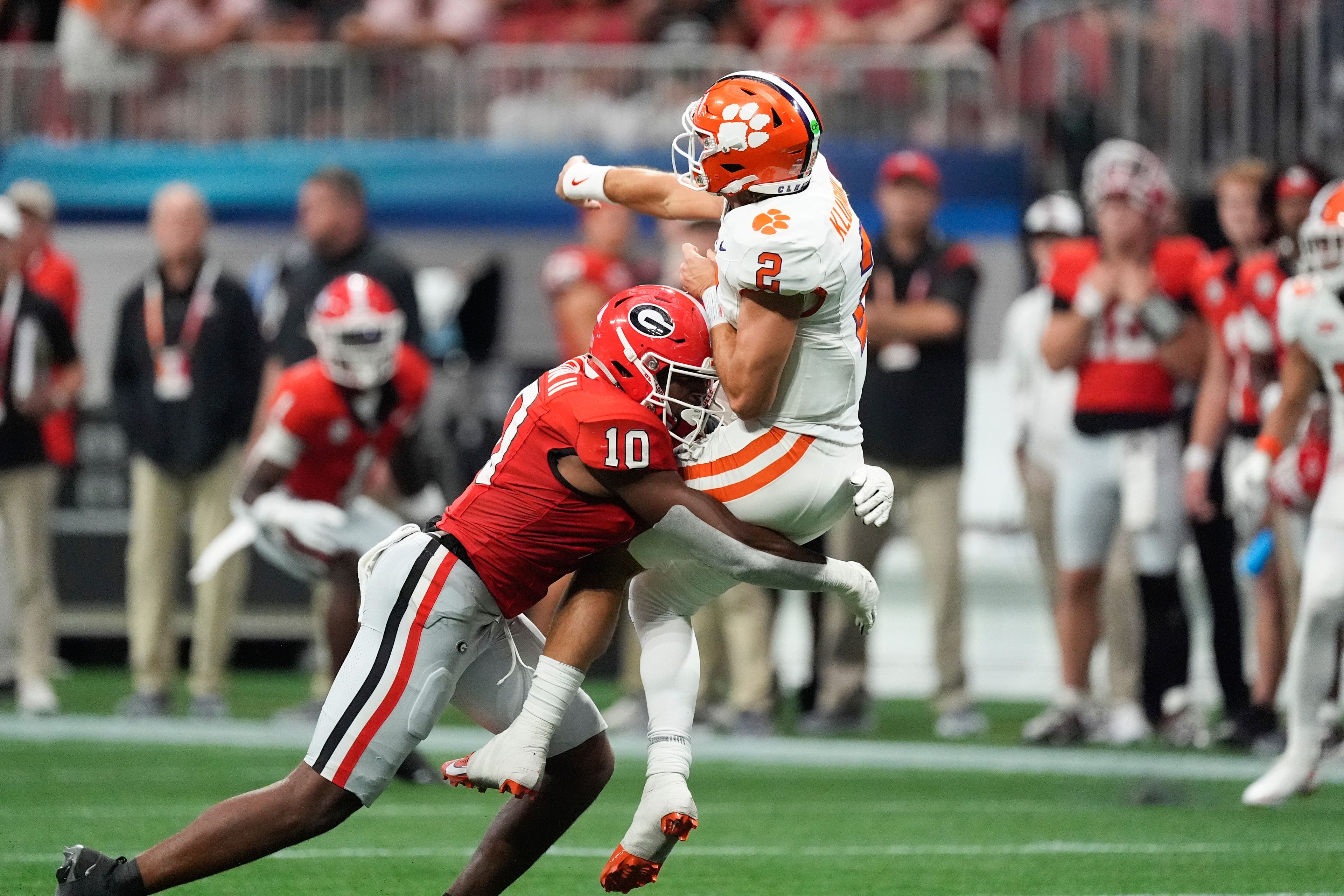 Clemson quarterback Cade Klubnik (2) is hit by Georgia linebacker Damon Wilson II (10) after releasing a pass during the second half of an NCAA college football game Aug. 31, 2024, in Atlanta. (AP Photo/John Bazemore)