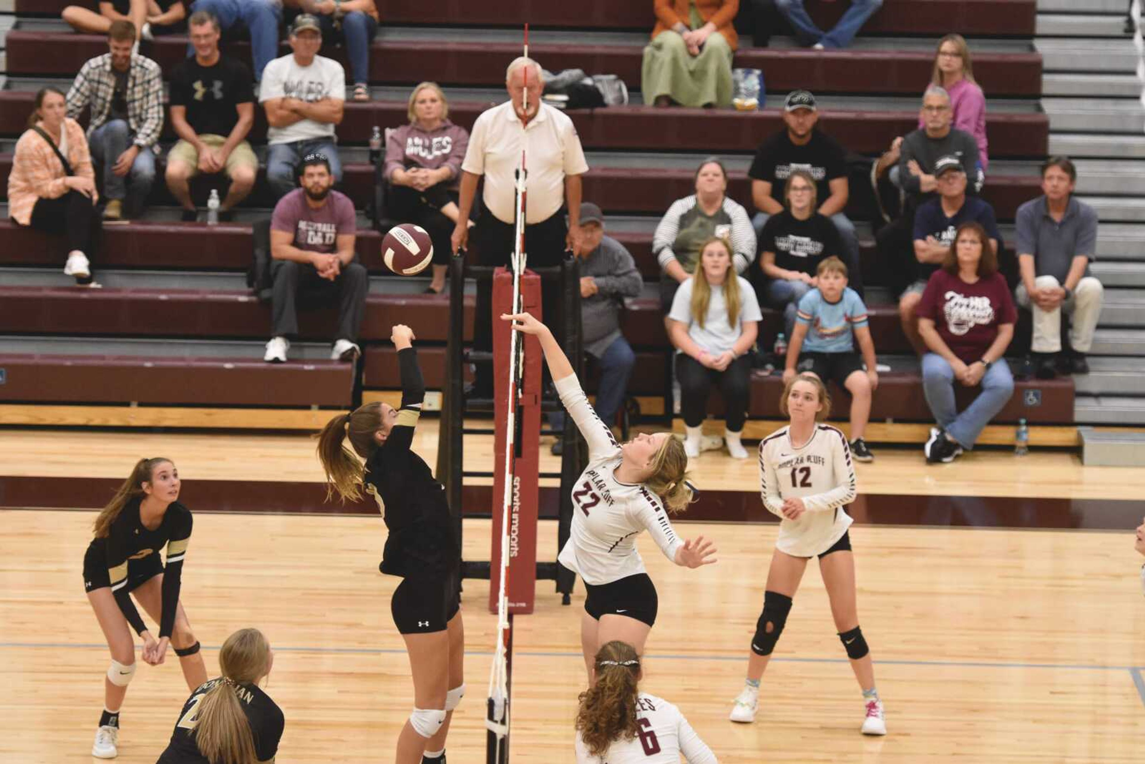 Poplar Bluff's Ireland Gowen tips the ball over the net while Doniphan's Kanzie Redus tries to block it on Monday, Oct. 3, 2022 in Poplar Bluff.