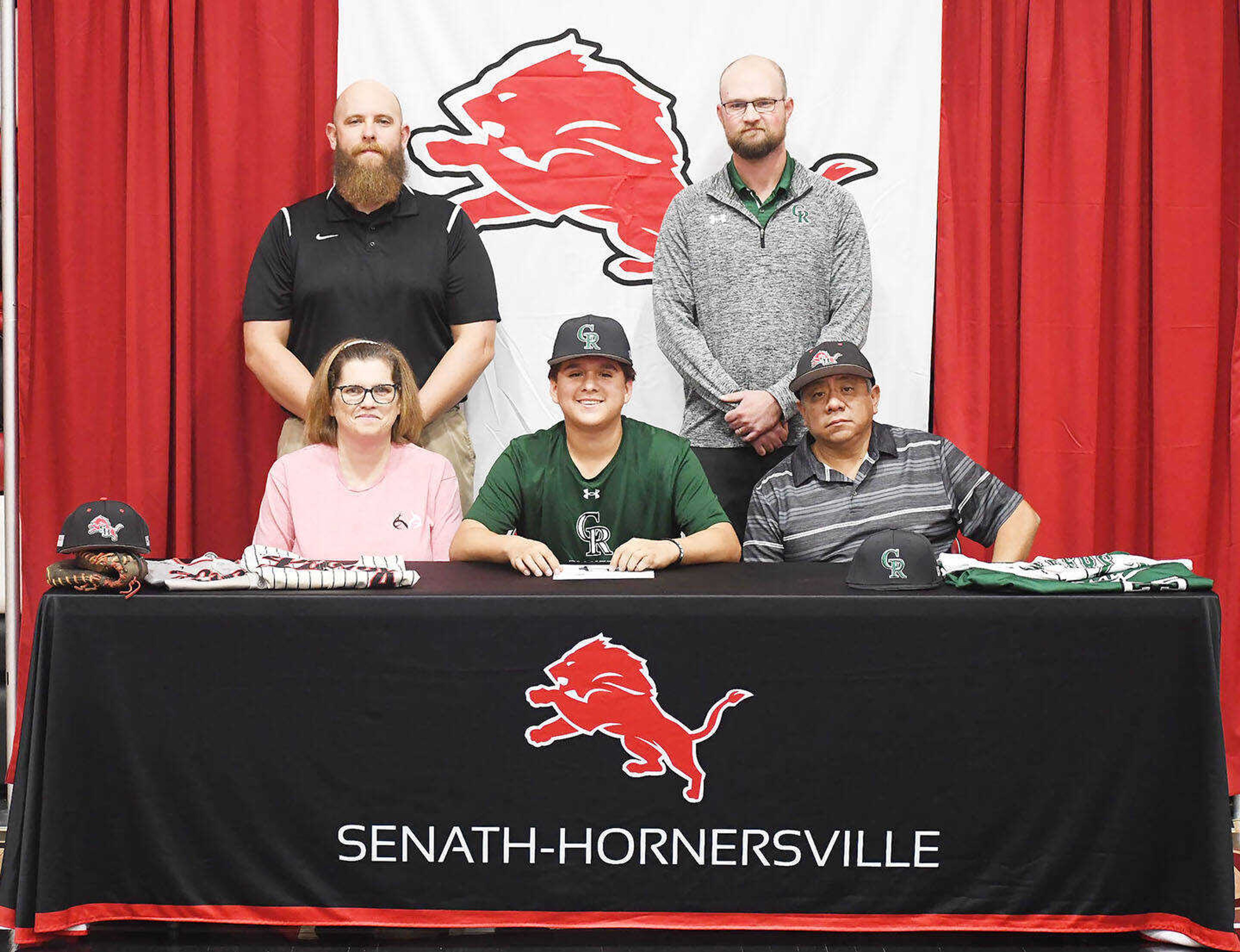 Senath-Hornersville baseball player Jesus "Chuy" Mendoza is flanked by his parents Mica and Jesus Mendoza, and Crowley's Ridge assistant coach Tray Malone and Pioneers' head coach Brenden Camp. 