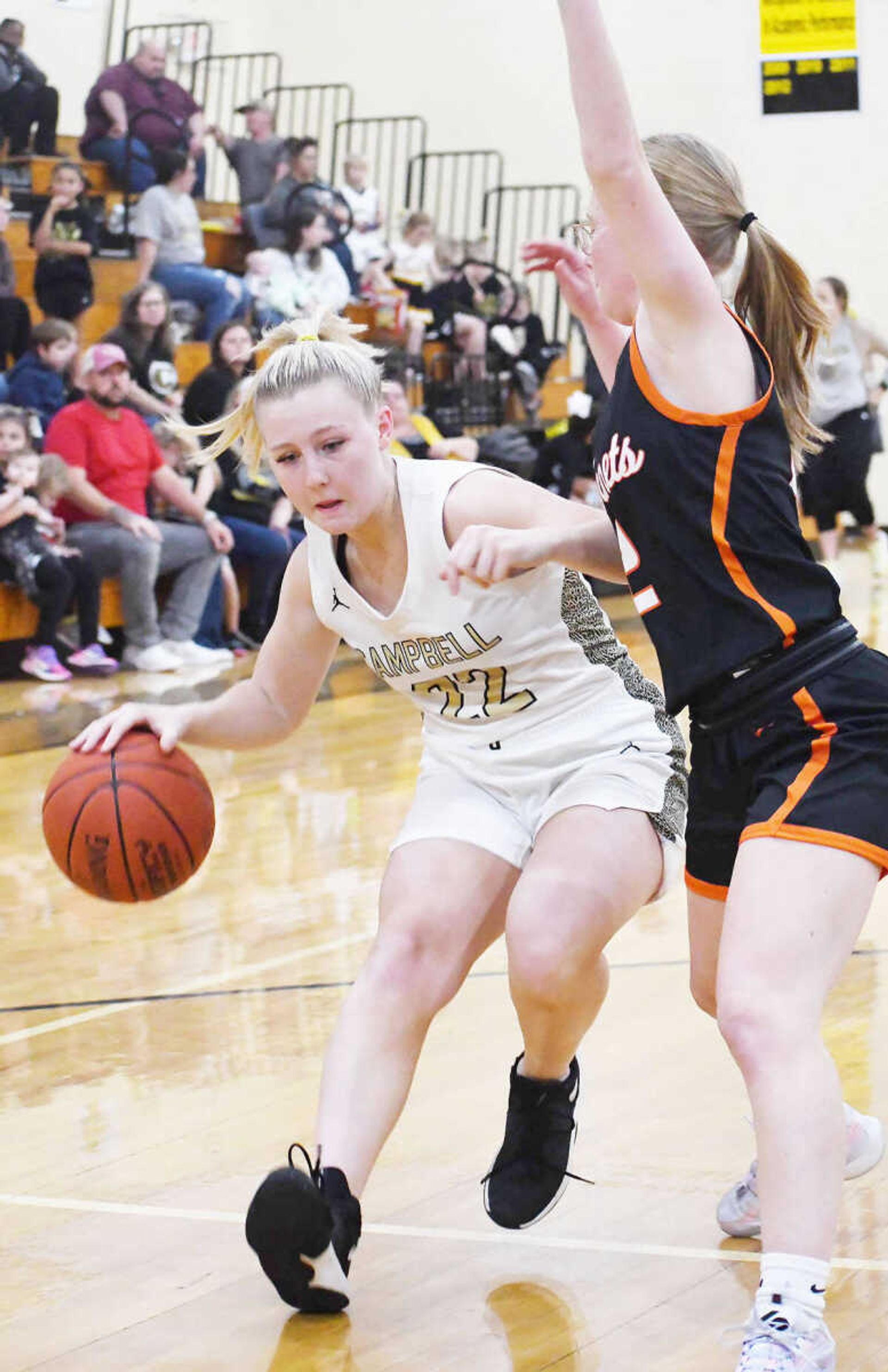 Campbell's Elyssa Schatz (22) looks for room to dribble while defended by a player from Advance during a jamboree game from Thursday, Nov. 16, 2023, in Campbell.