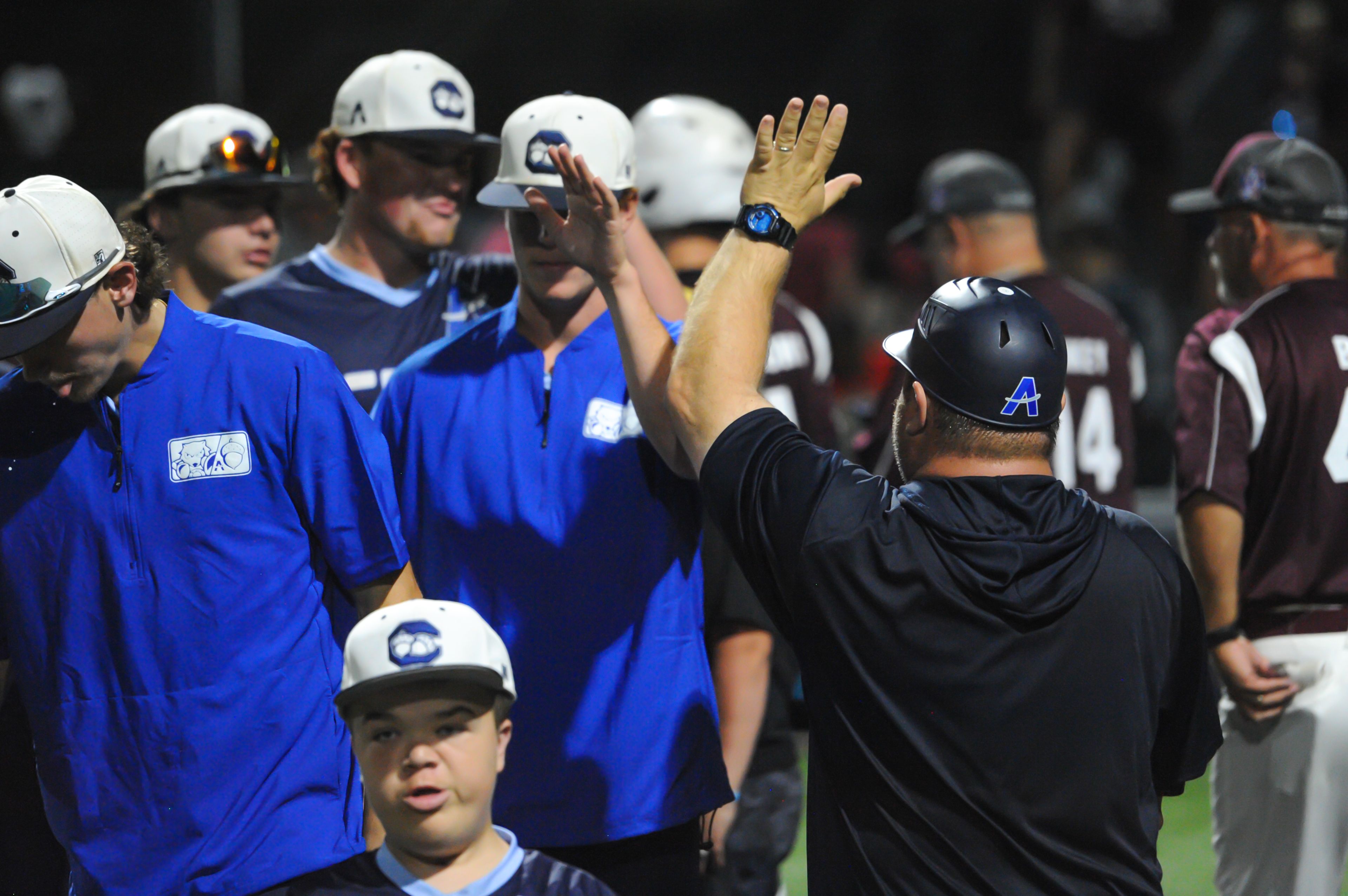 Aycorp coach Michael Minner (right) high-fives his team after an August 14, 2024 Babe Ruth World Series game between the Aycorp Fighting Squirrels and the Altoona, Pennsylvania, at Capaha Field in Cape Girardeau, Mo. Aycorp defeated Altoona, 12-11.