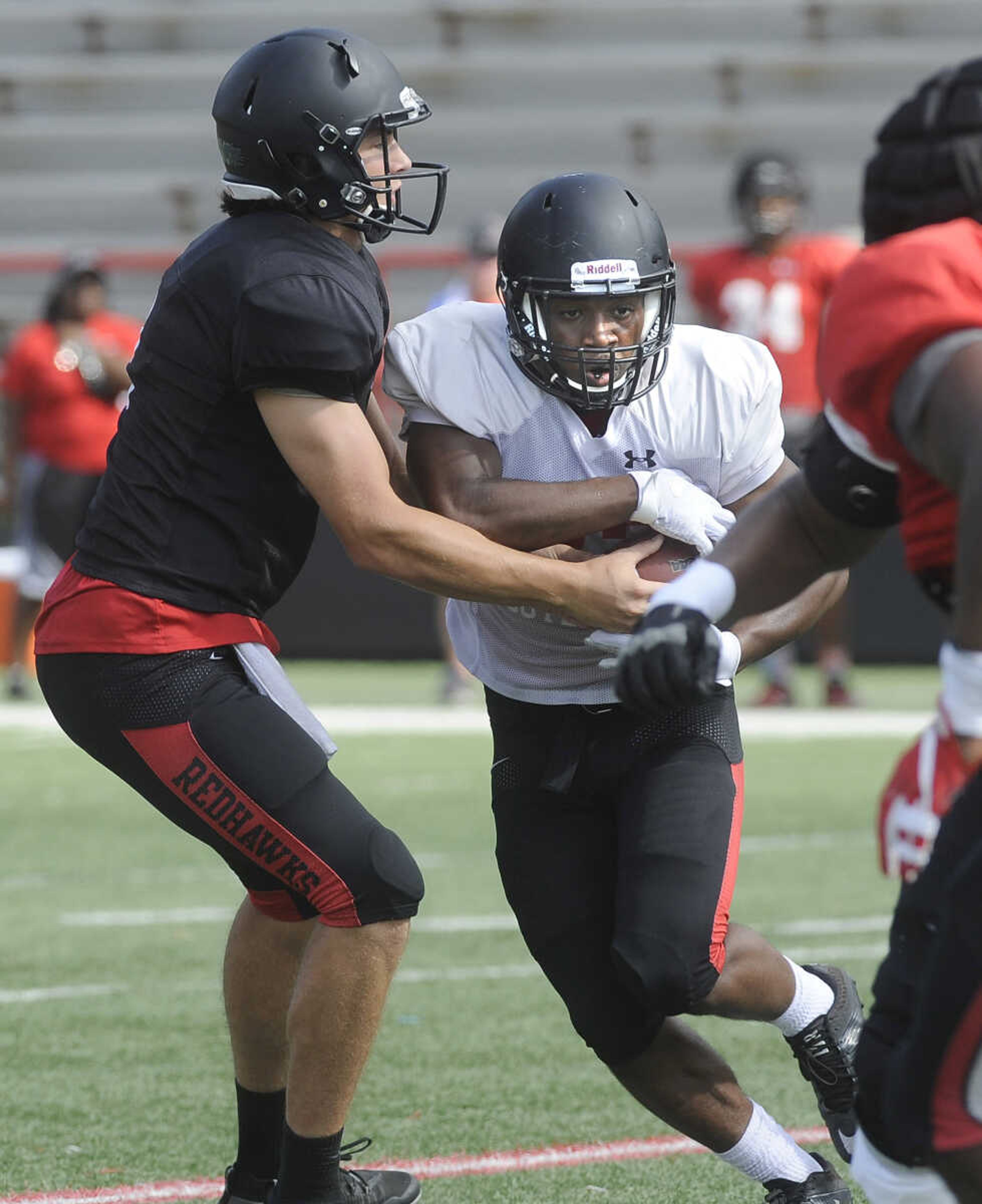 FRED LYNCH ~ flynch@semissourian.com
Southeast Missouri State quarterback Jacob Buie hands off to running back Geno Hess during the last preseason scrimmage Saturday, Aug. 18, 2018 at Houck Field.