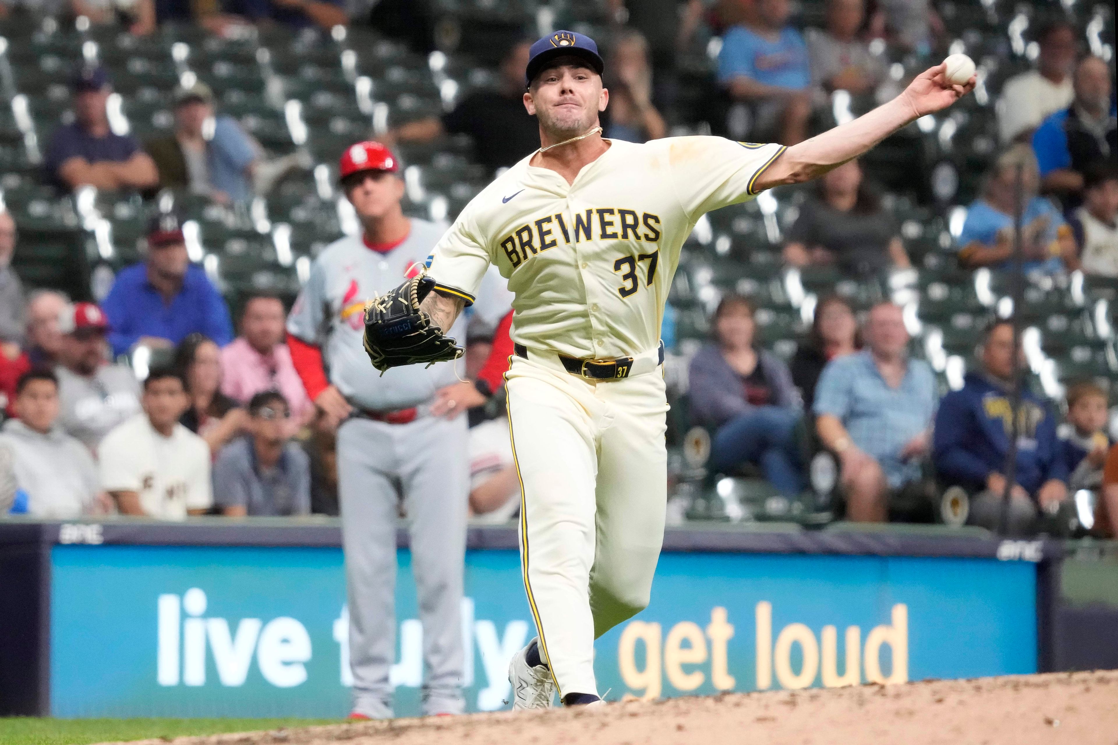 Milwaukee Brewers pitcher DL Hall throws to first for the out on a bunt by St. Louis Cardinals' Michael Siani during the sixth inning of a baseball game Wednesday, Sept. 4, 2024, in Milwaukee. (AP Photo/Kayla Wolf)