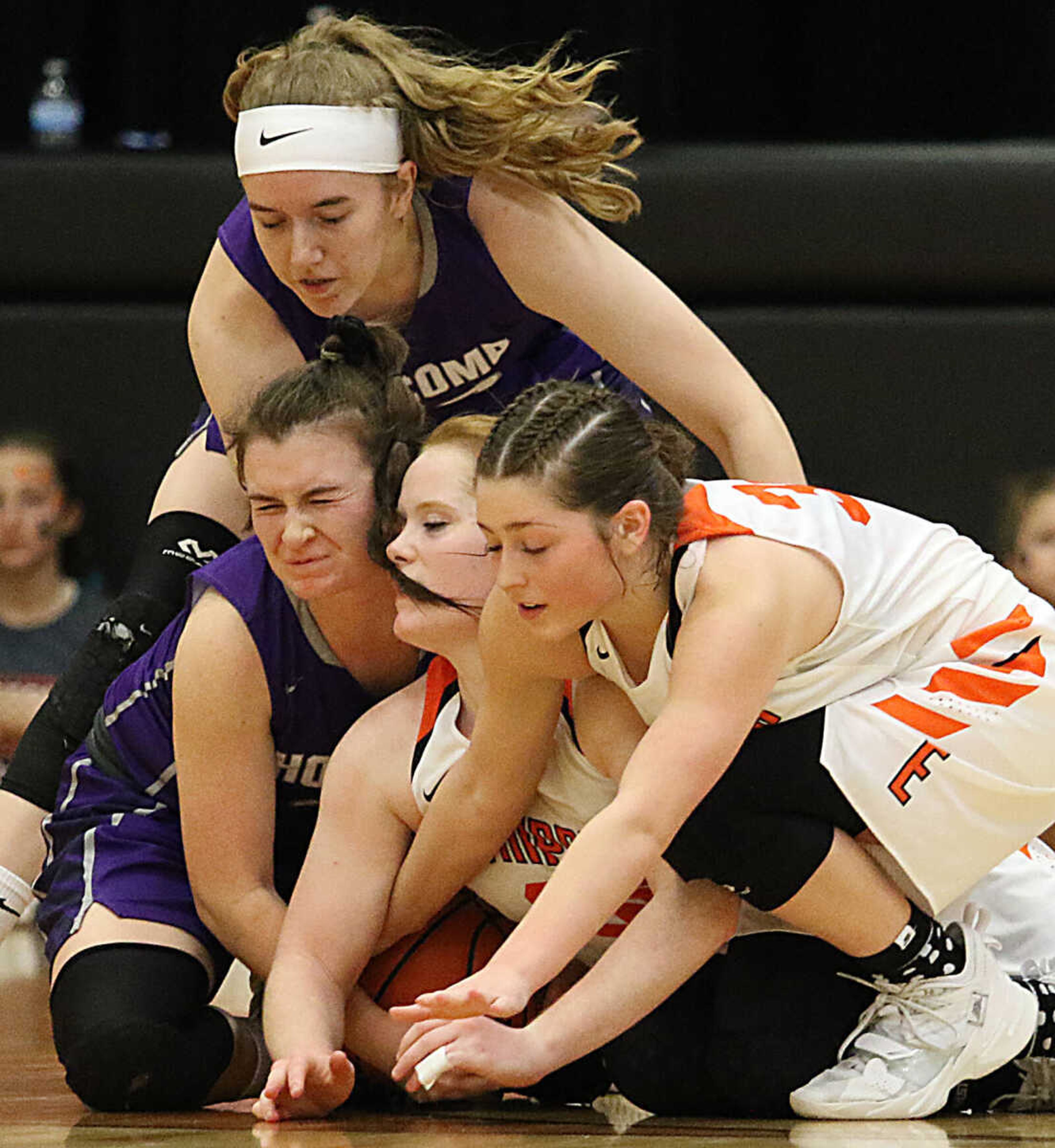 Holcomb's Selena Burress, top, and Alyssa Brown, left, battle Ellington's Gretchen Hackworth, center, and Kaylee King, right,  for a loose ball during the 2021 MSHSAA Class 2 sectional playoff last season at Ellington.