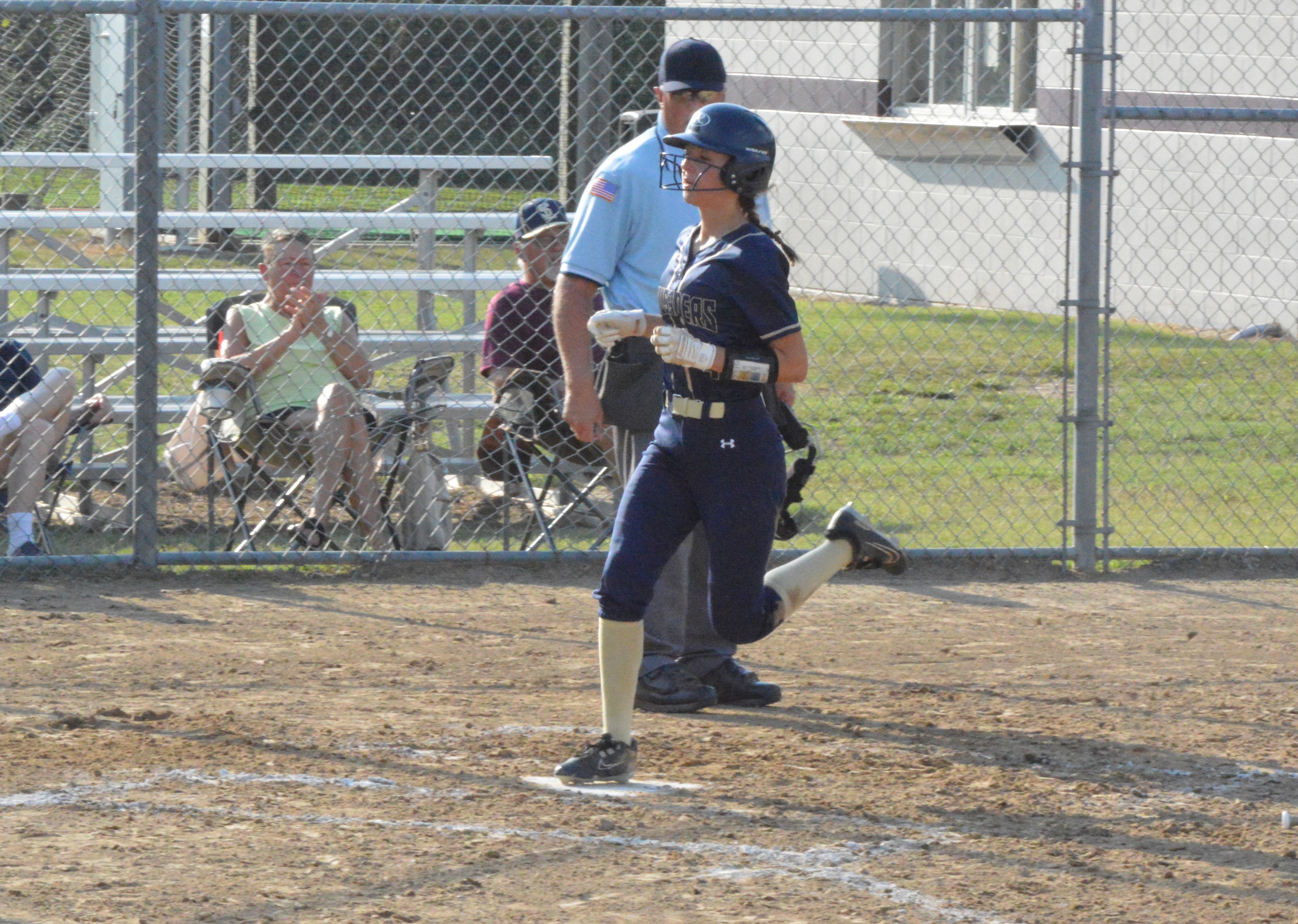 Saxony Lutheran Rebekkah Yunck touches home plate to score the Crusaders' lone run of the game against Kelly on Thursday, Sept. 19. 