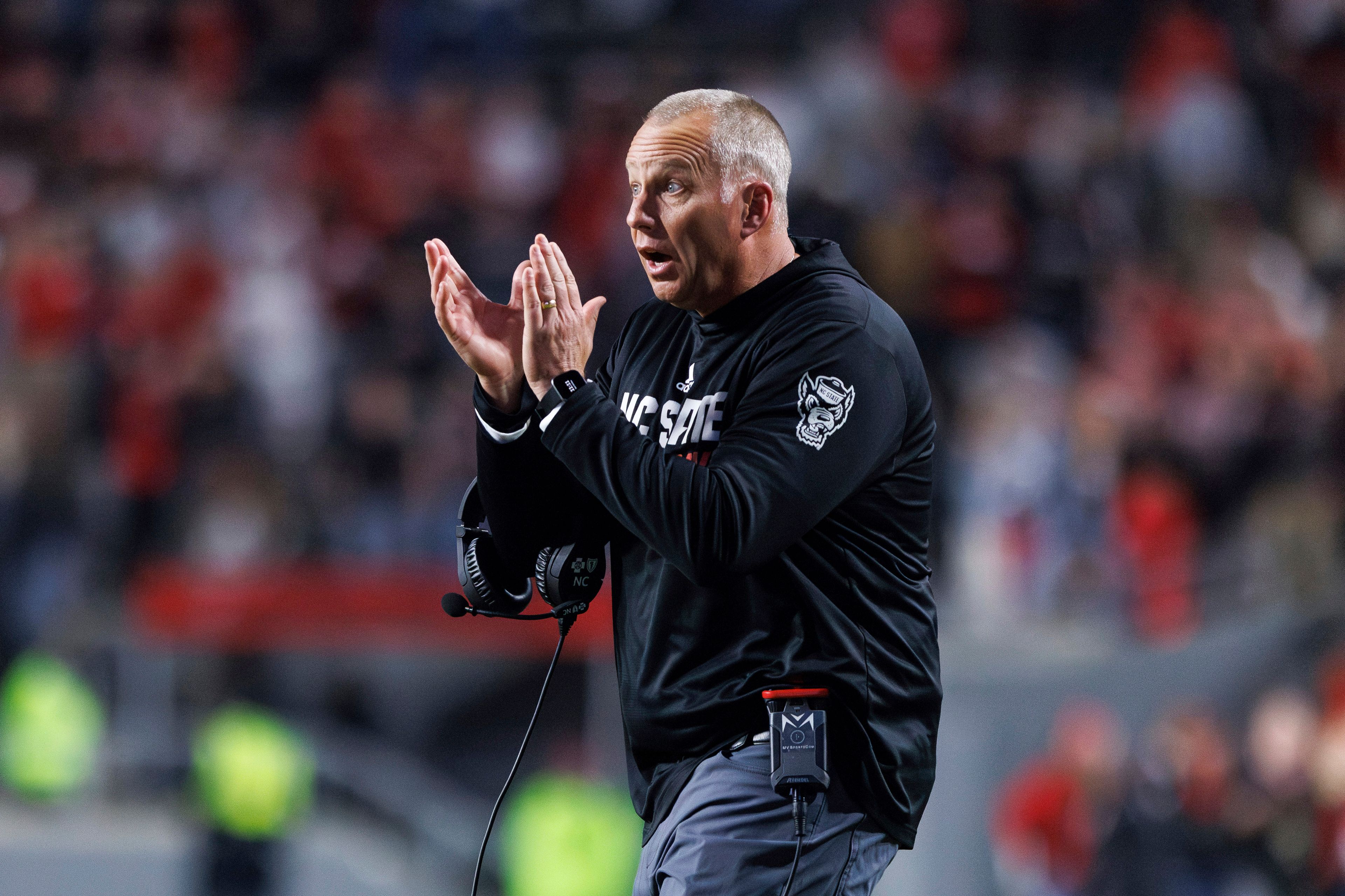 FILE - North Carolina State head coach Dave Doeren claps for his team during an NCAA college football game against Miami in Raleigh, N.C., Nov. 4, 2023. (AP Photo/Ben McKeown, File)