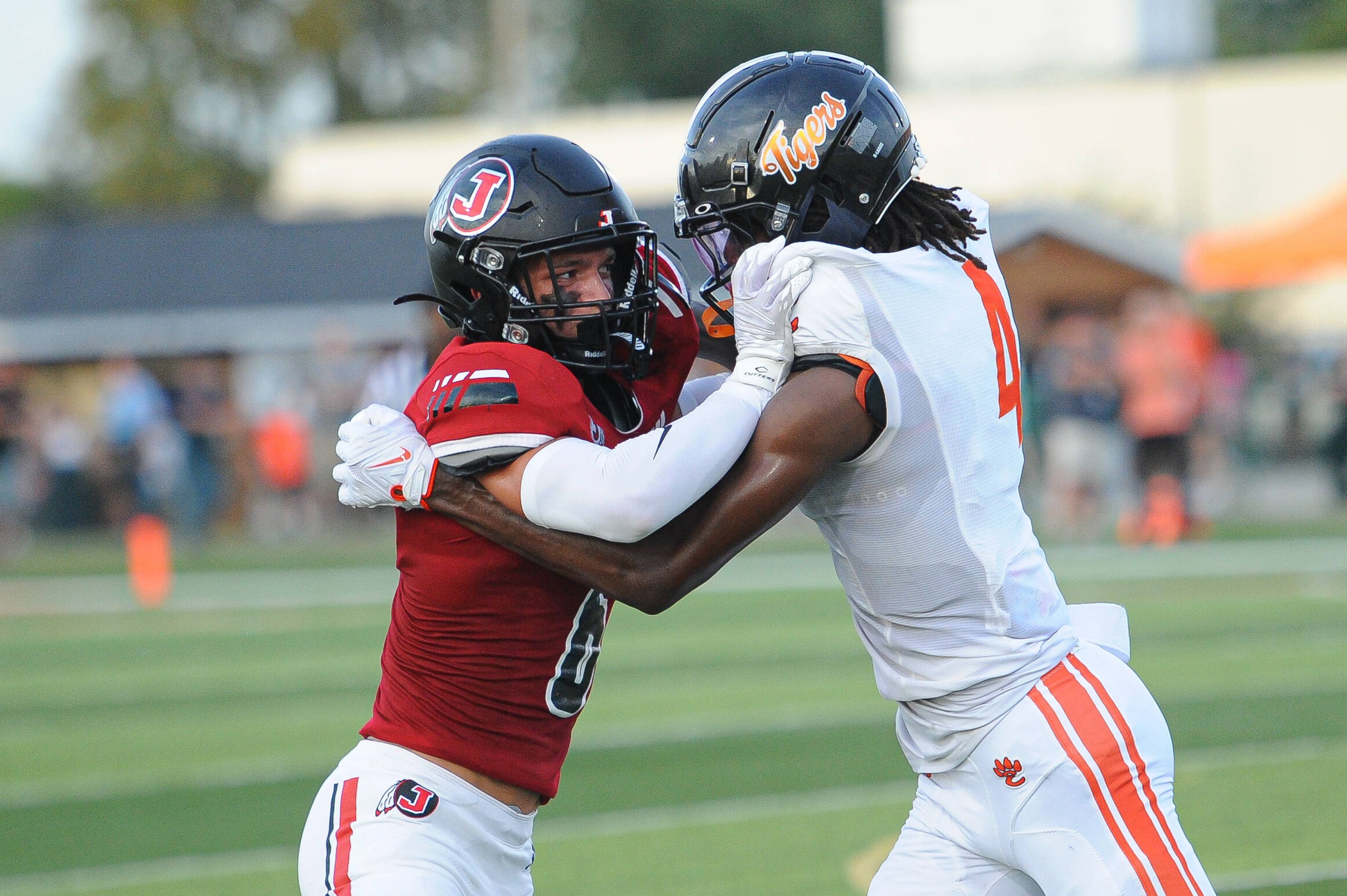 Jackson's Gavin Alspaugh (left) fights through a block by Edwardsville's Devyon Hill-Lomax (right) during a Saturday, September 14, 2024 game between the Edwardsville Tigers and the Jackson Indians at Edwardsville High School in Edwardsville, Ill. Edwardsville defeated Jackson, 41-7.
