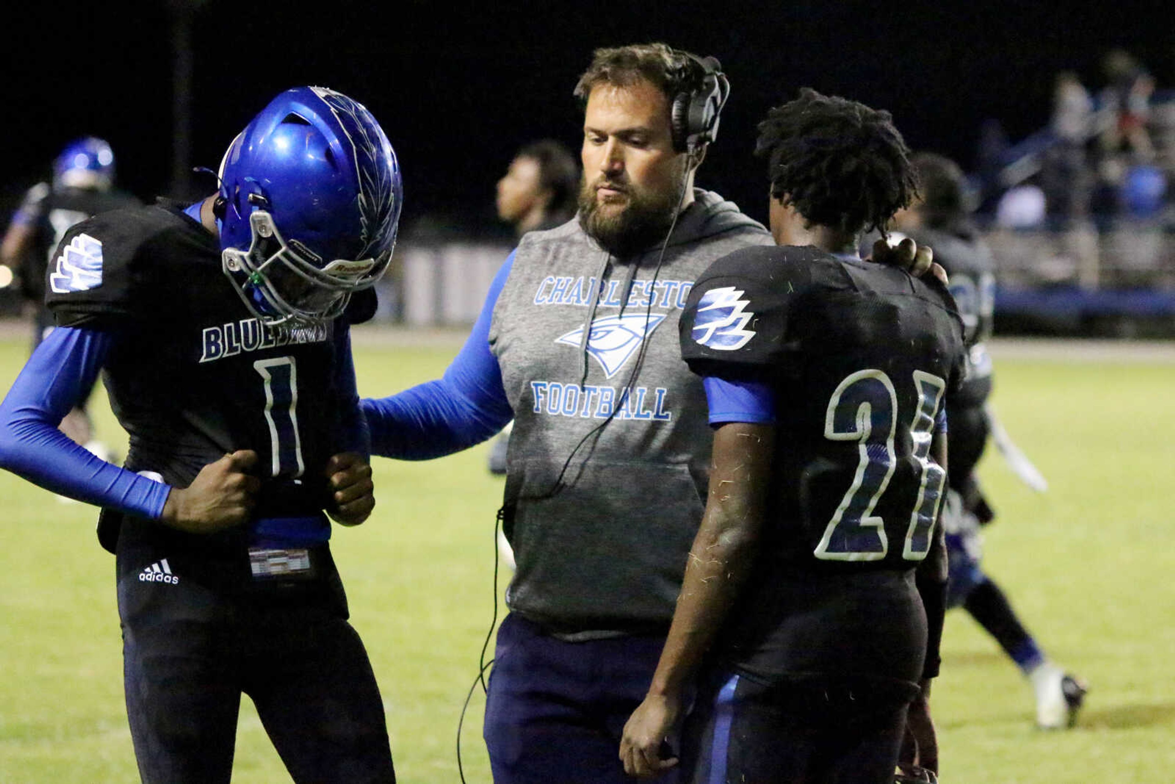 Charleston coach Justin Hutchings consoles Bluejay players following&nbsp;a 14-12 loss to Chaffee at John Harris Marshall Stadium on Thursday, August 31, 2023.&nbsp;