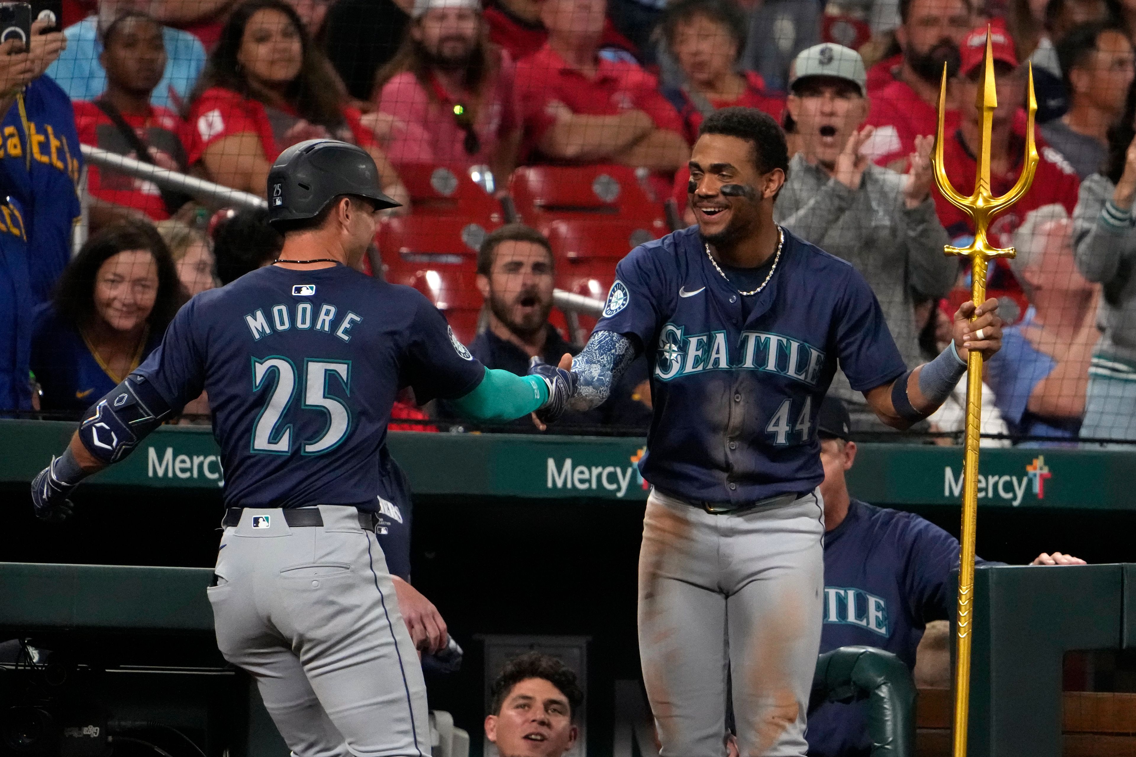 Seattle Mariners' Dylan Moore (25) is congratulated by teammate Julio Rodriguez (44) after hitting a two-run home run during the sixth inning of a baseball game against the St. Louis Cardinals Friday, Sept. 6, 2024, in St. Louis. (AP Photo/Jeff Roberson)