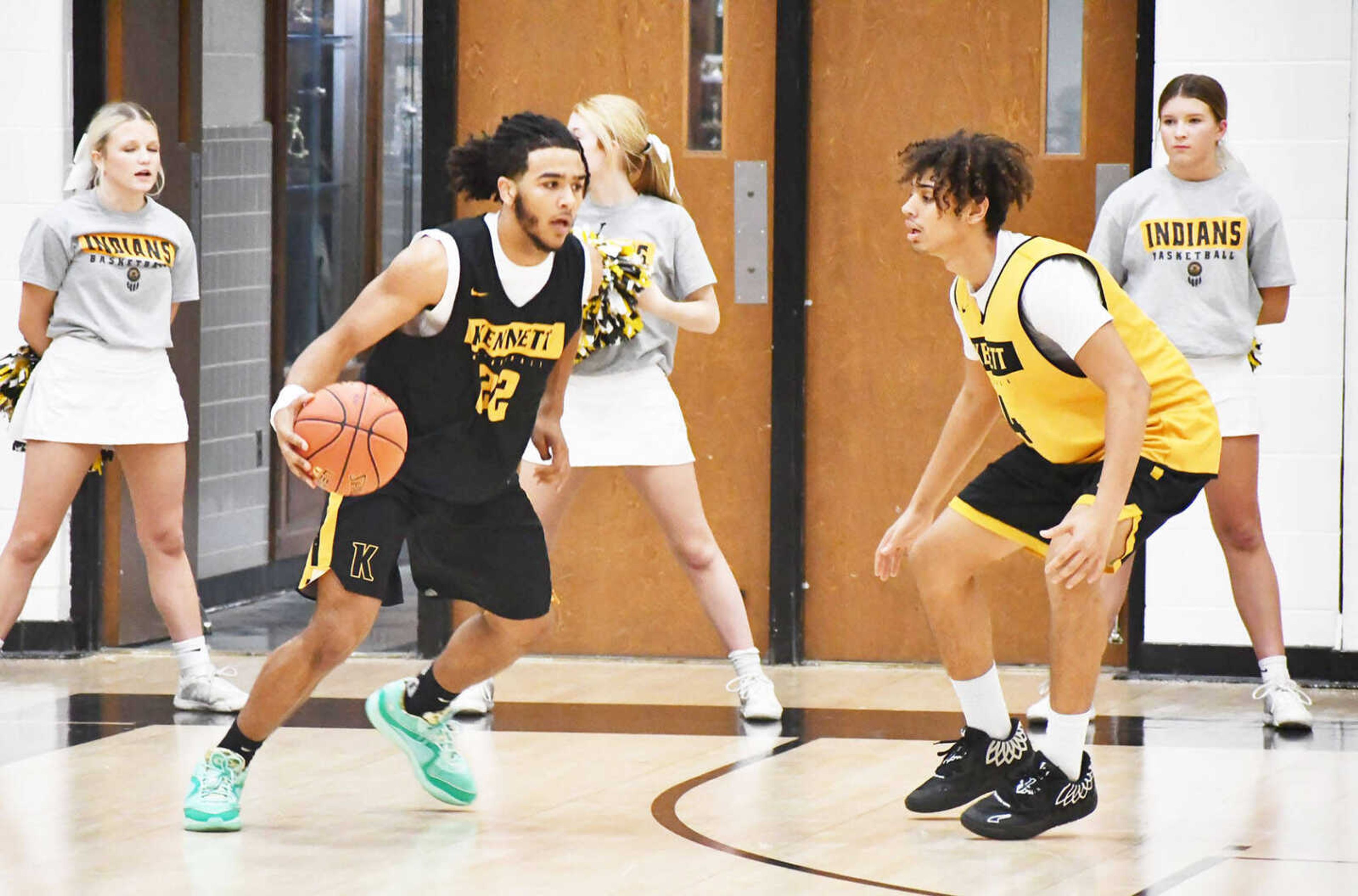 Kennett High School boys basketball player Chris Jefferson (left) dribbles the ball in the front court while defended by Antonio Flakes (right) during a sports drink scrimmage dated Tuesday, Nov. 14, in the main gymnasium. The scrimmage marked the formal beginning to the 2023-24 season.