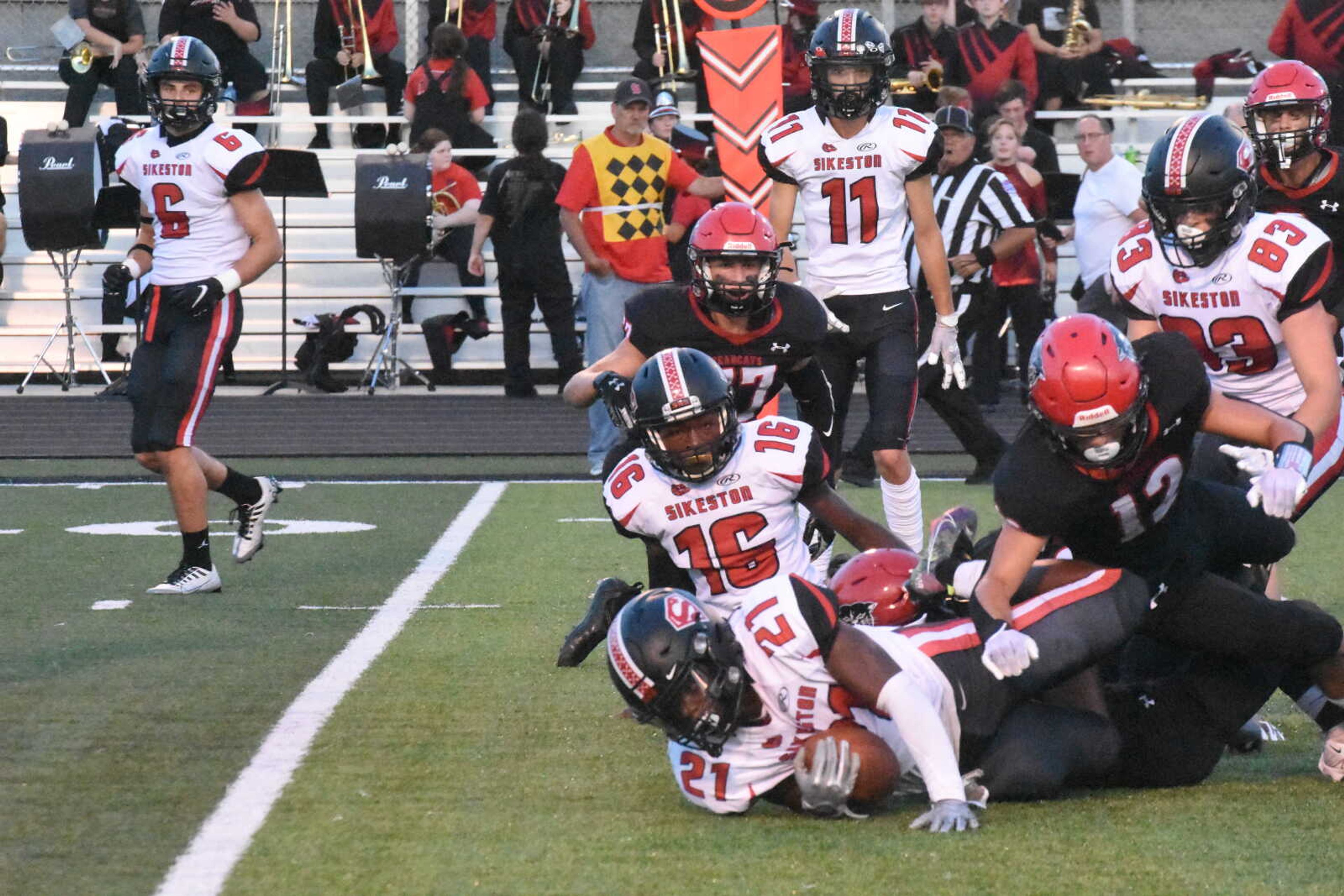 Dexter's Kaeden Kennedy (12) tackles Sikeston's Trez Clark (21).