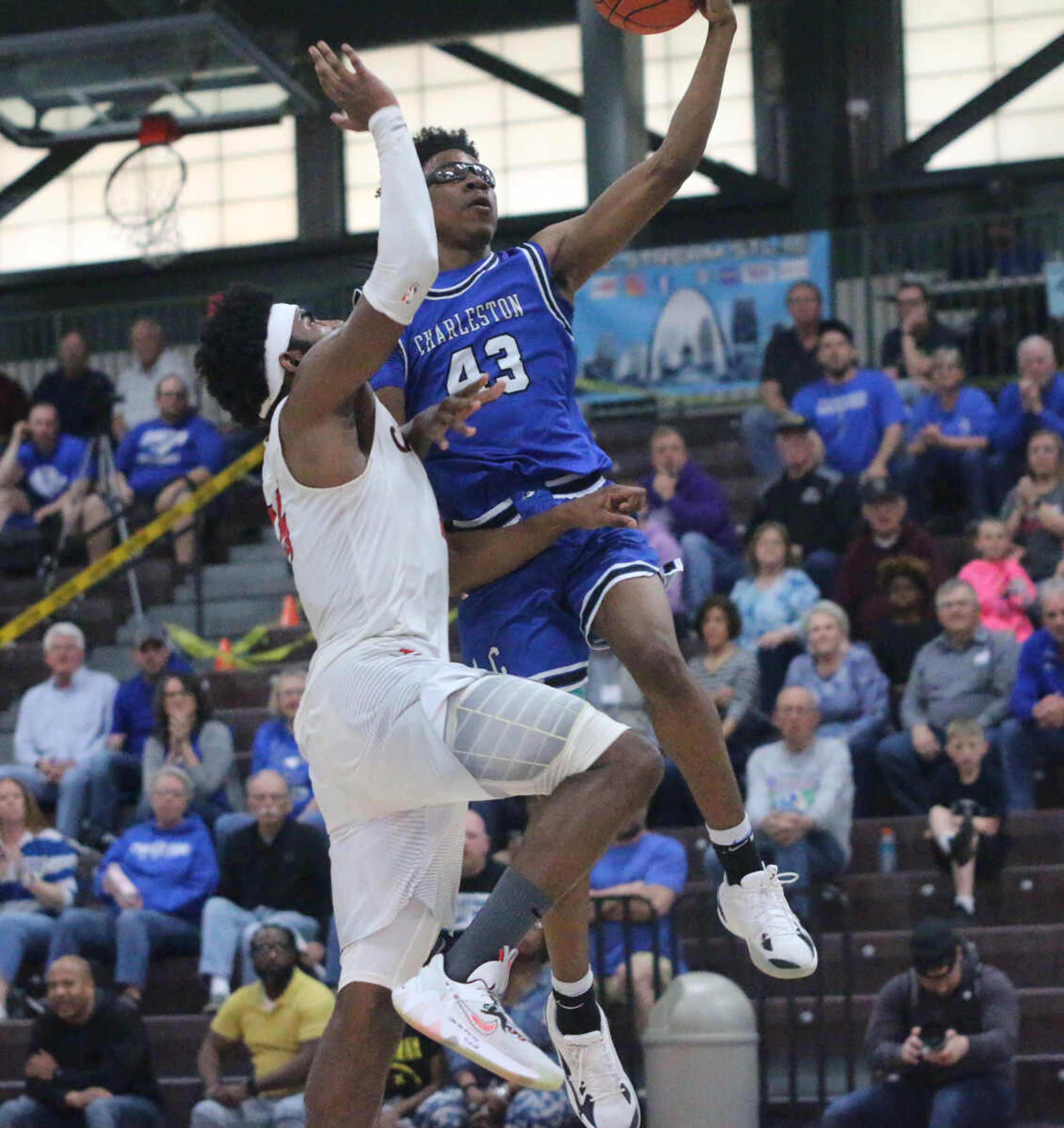 Rico Coleman finishes a heavily-contested shot at the rim during Charleston's 74-61 win over Bishop DuBourg in a Class 3 quarterfinal at the Farmington Community Civic Center on Saturday, March 5. (Dennis Marshall/Standard-Democrat)