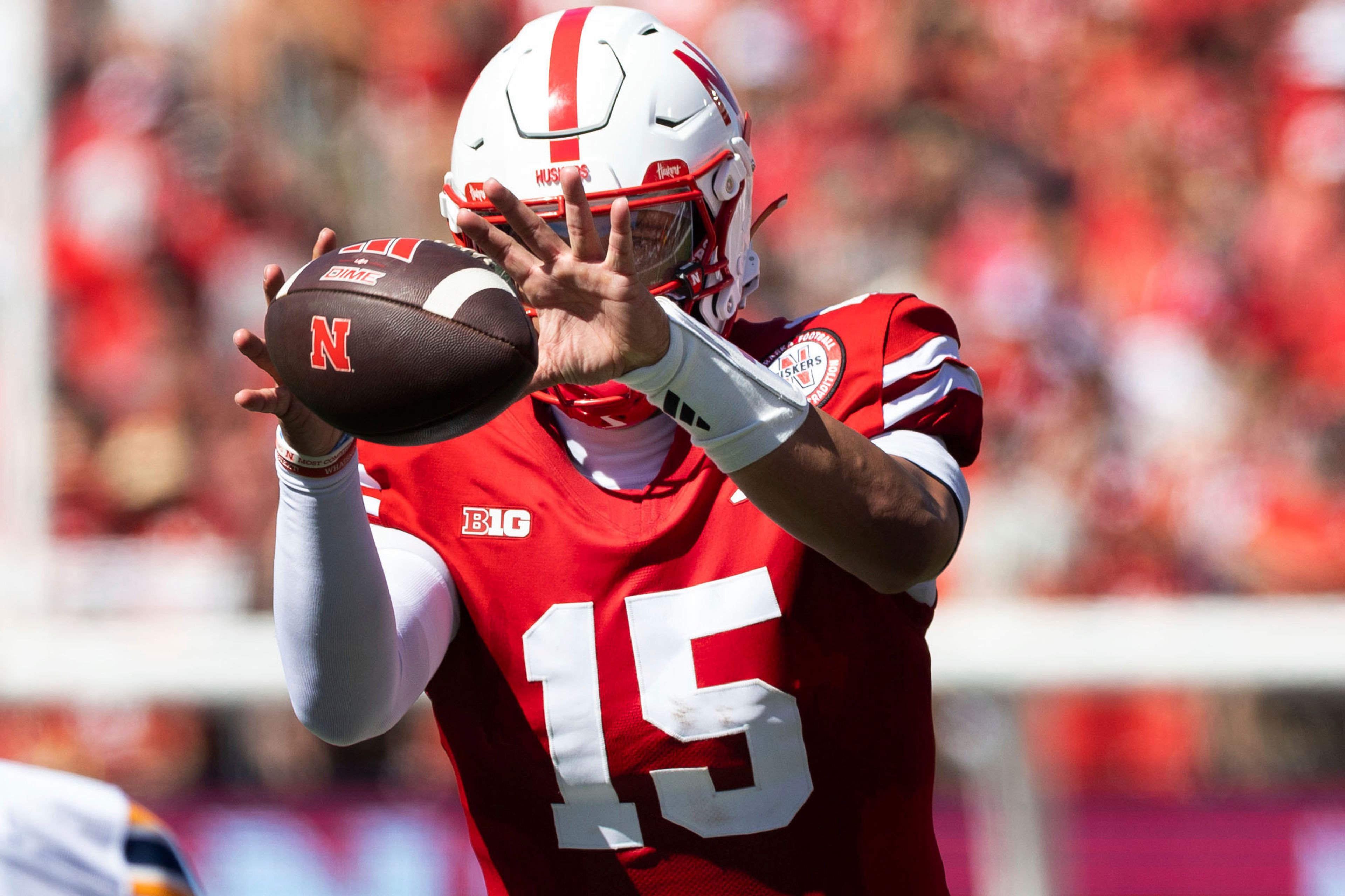 Nebraska's Dylan Raiola (15) takes a snap during the first half of an NCAA college football game against UTEP in Lincoln, Neb., Saturday, Aug. 31, 2024. (Chris Machian/Omaha World-Herald via AP)