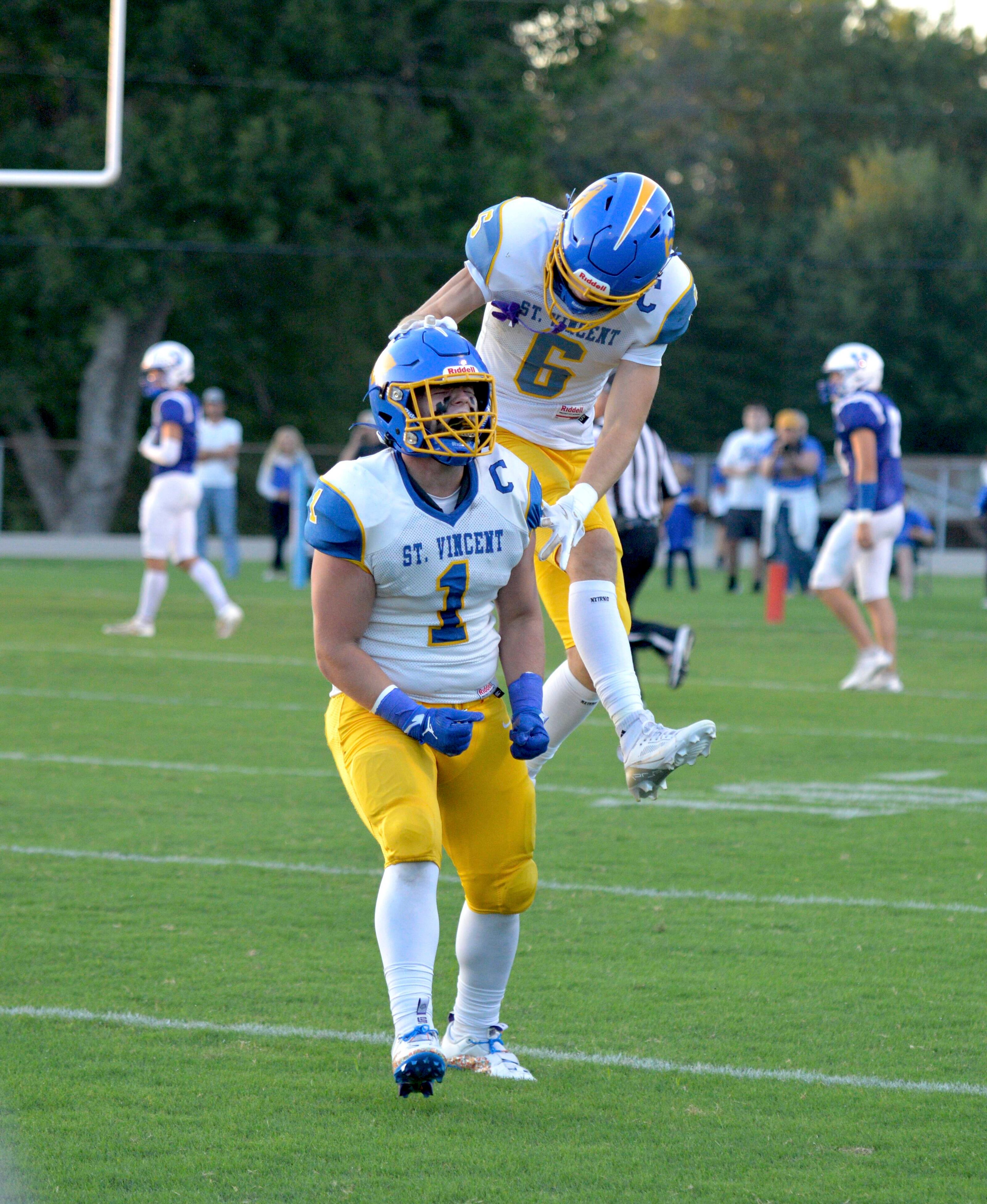 St. Vincent receiver Clayton Gremaud celebrates a touchdown scored by running back Cruz Reitzel against Valle Catholic defenders on Friday, Sept. 6, in Ste. Genevieve, Mo. 