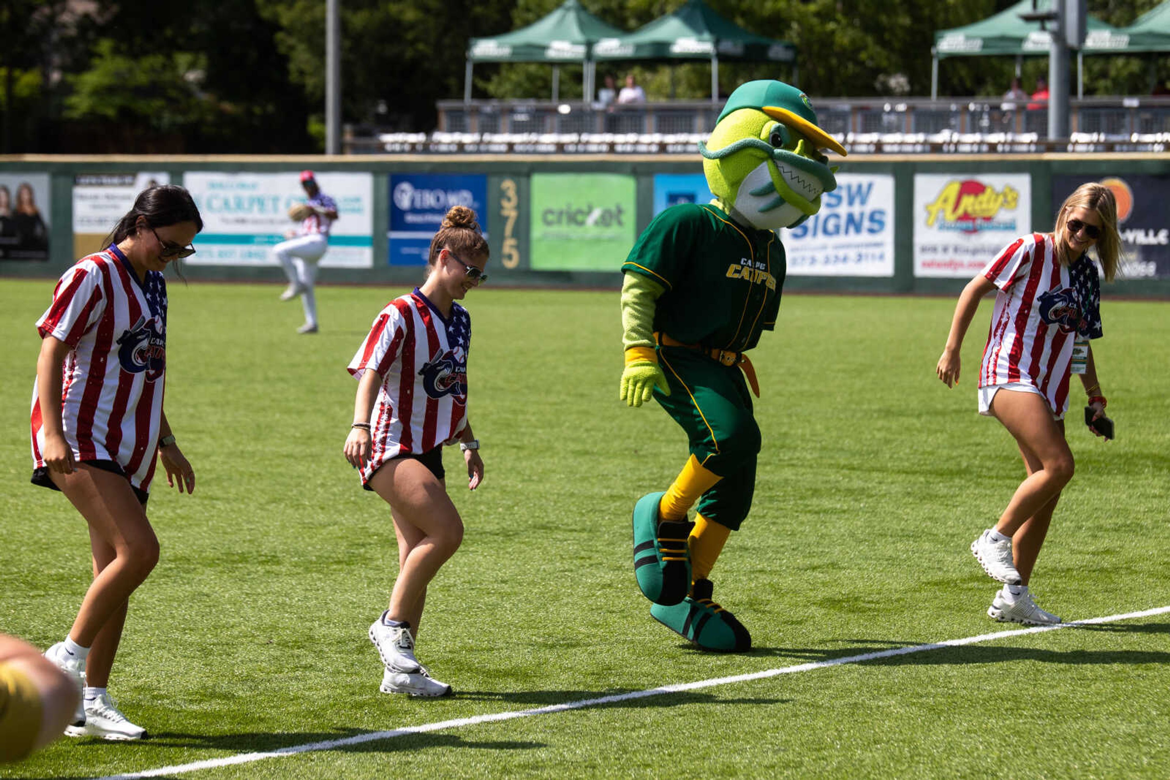 The Cape Catfish mascot dances to "Cotton Eyed Joe" with staff members during the game.