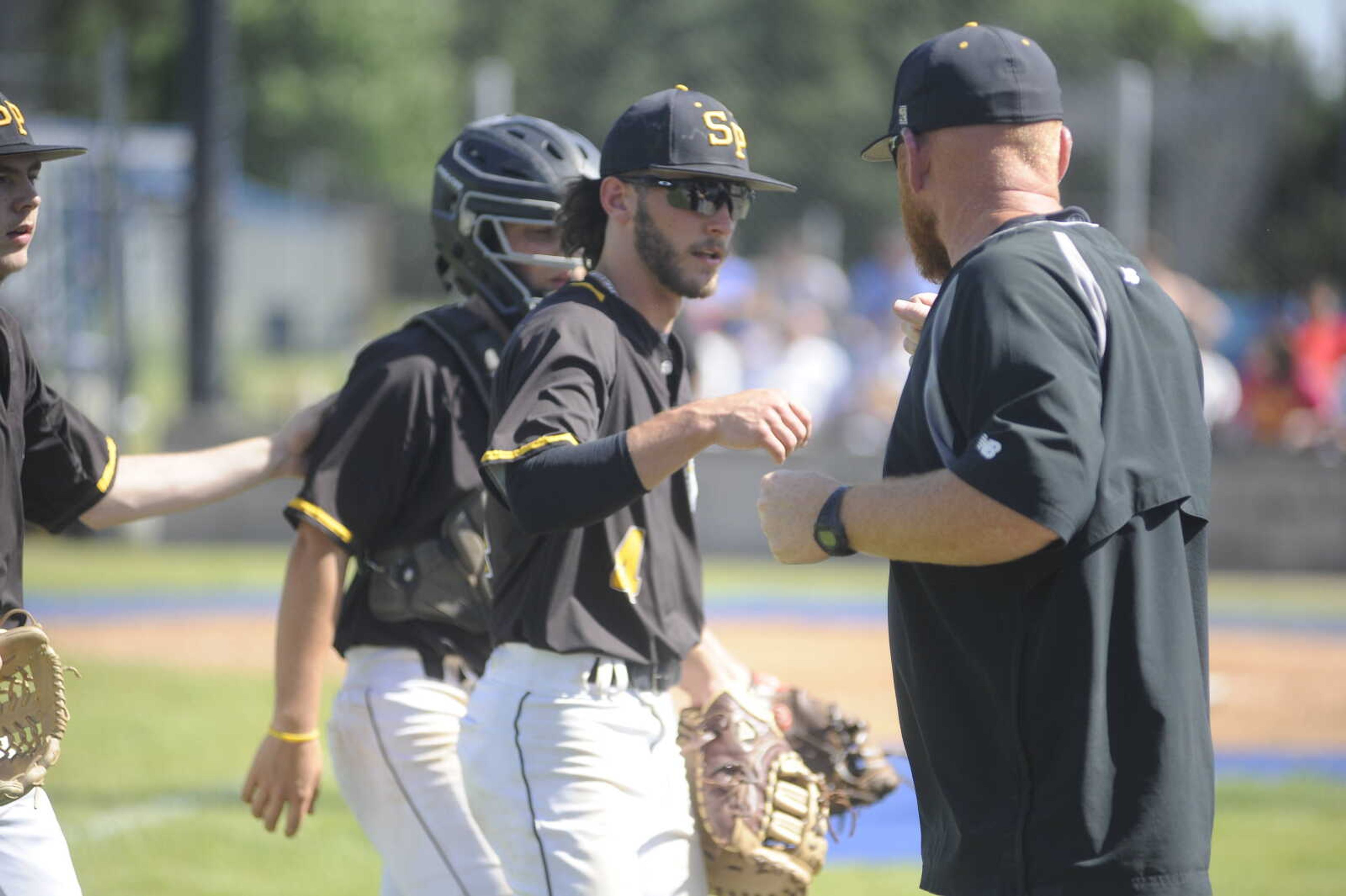 South Pemiscot High School senior baseball player Jadie Morton is congratulated by Bulldog coach Jason House following an inning of work in the MSHSAA Class 2 District 1 Tournament against Bernie last month.