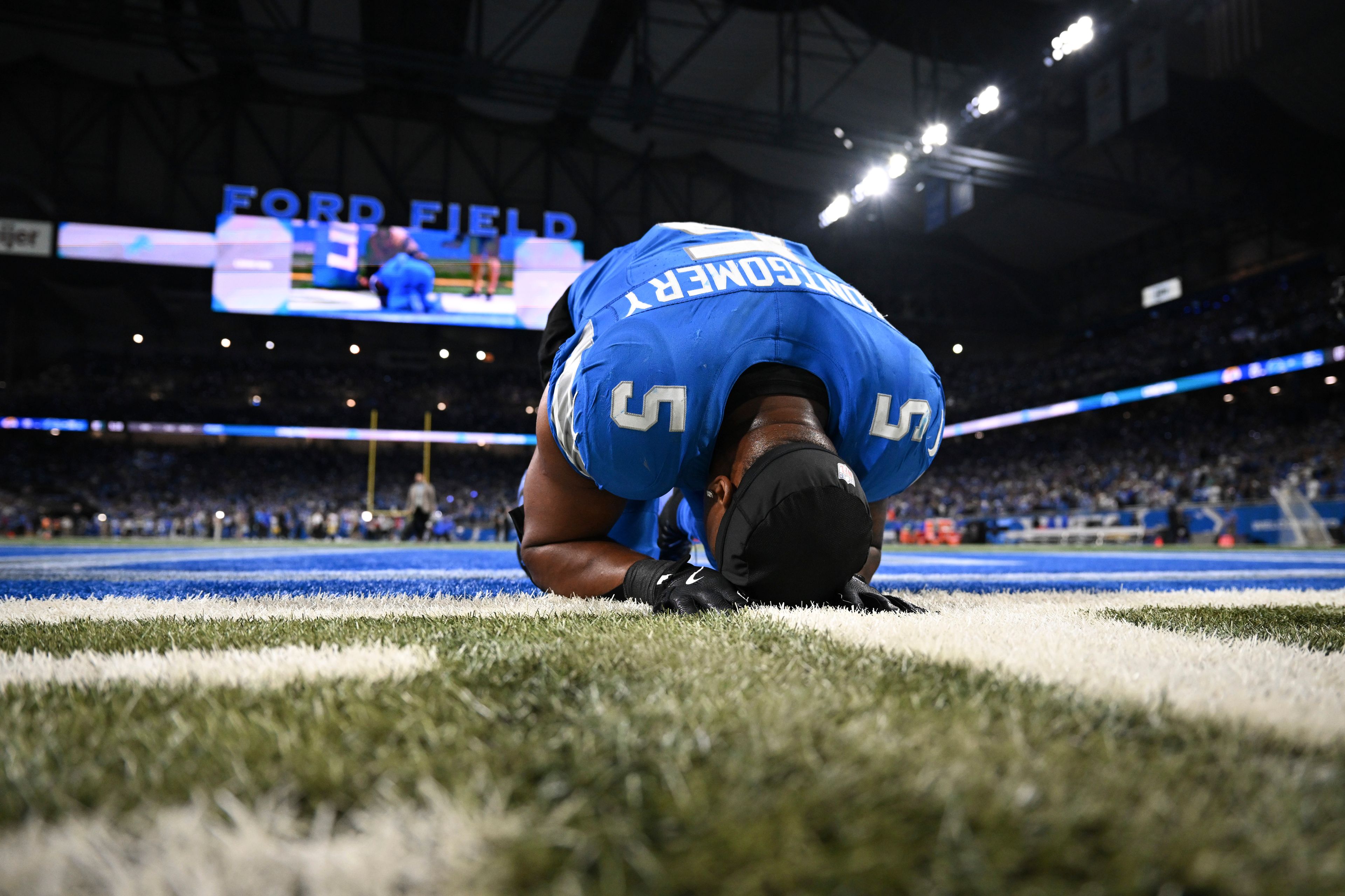 Detroit Lions running back David Montgomery (5) takes a moment after scoring a one-yard touchdown run against the Los Angeles Rams during overtime in an NFL football game in Detroit, Sunday, Sept. 8, 2024. (AP Photo/David Dermer)