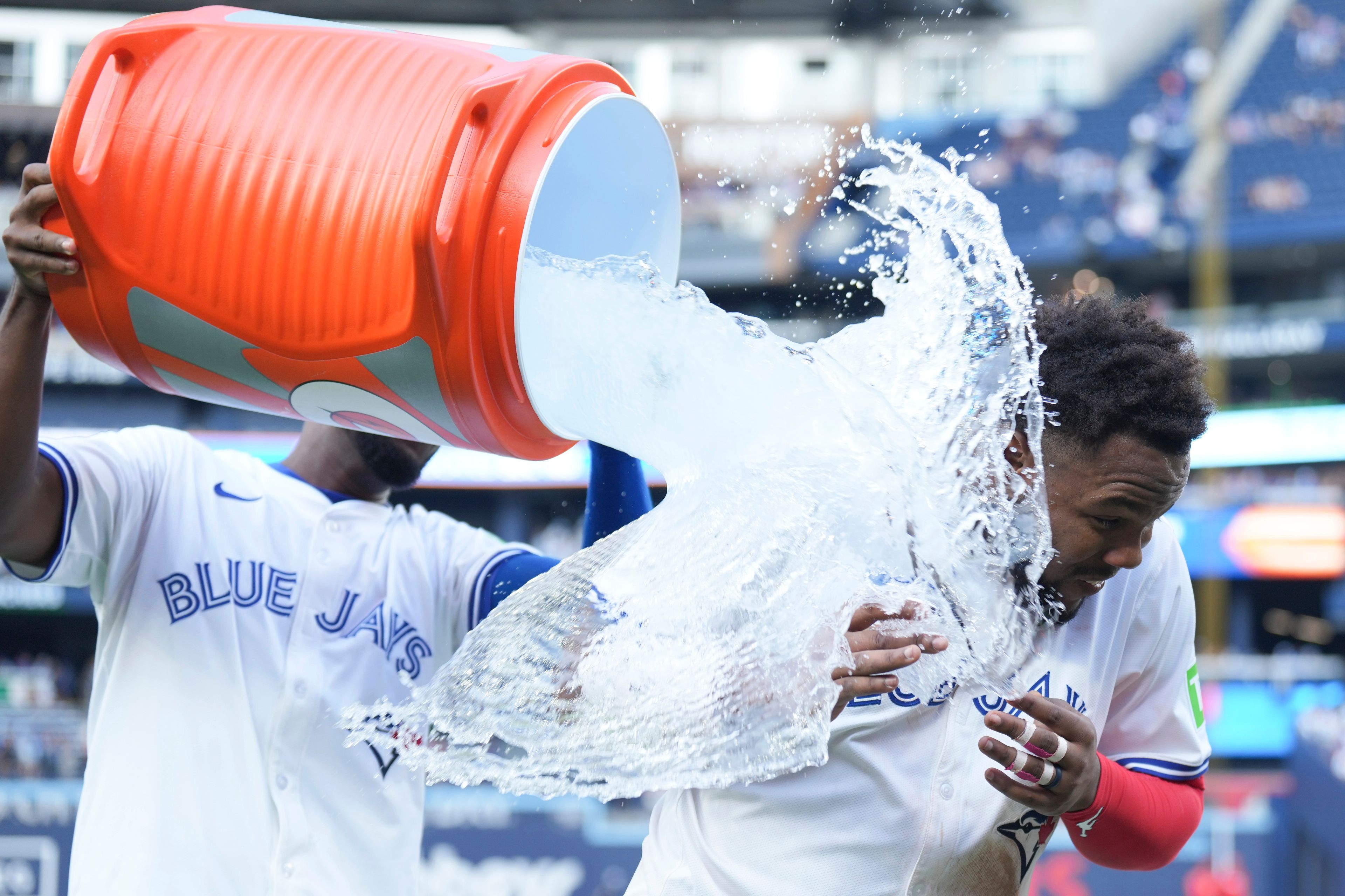 Toronto Blue Jays' Vladimir Guerrero Jr. is doused after defeating the St. Louis Cardinals in interleague MLB baseball action in Toronto, Saturday, September 14, 2024. (Chris Young/The Canadian Press via AP)