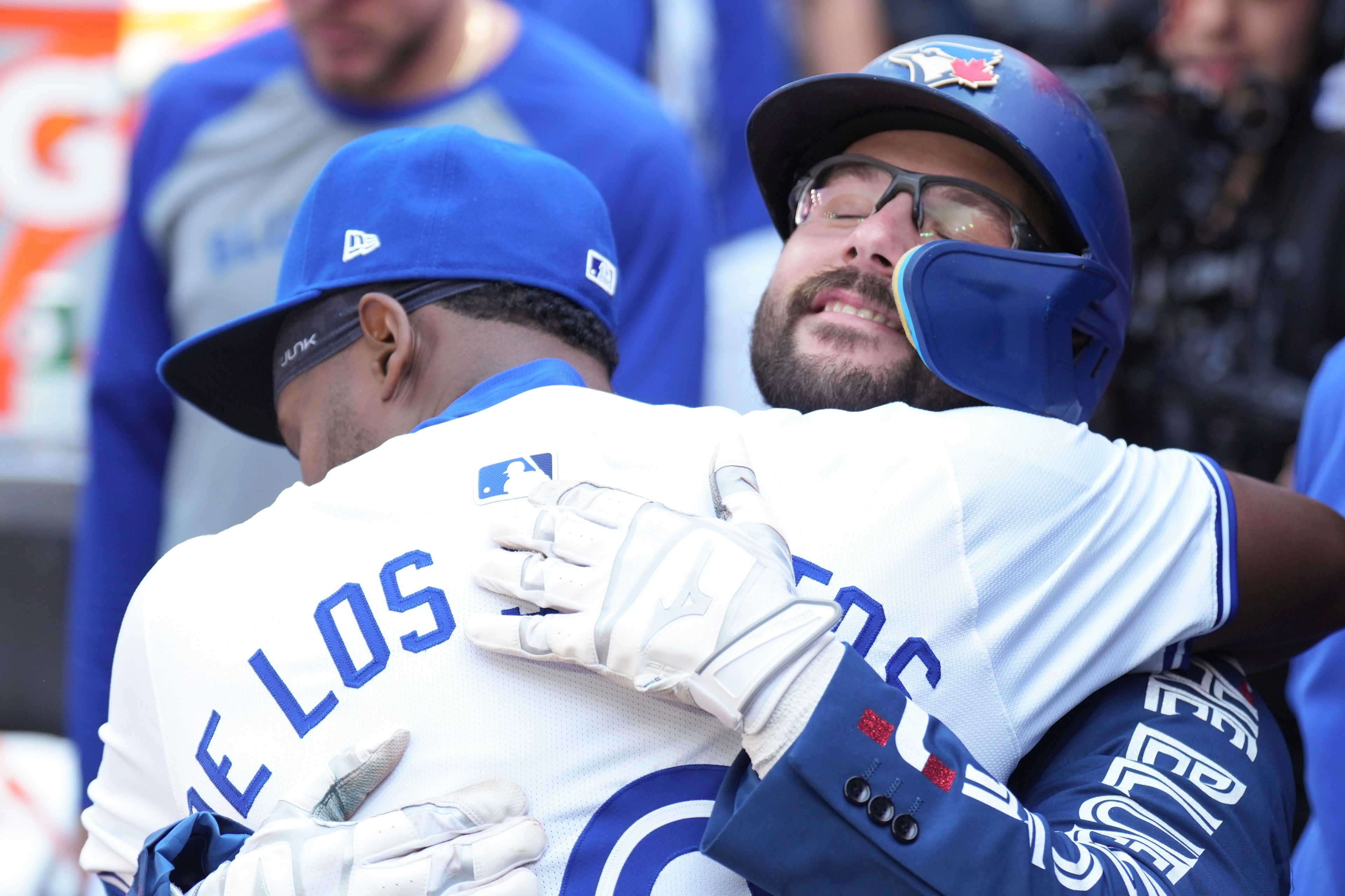 Toronto Blue Jays' Davis Schneider celebrates in the dug out with teammate Luis De Los Santos after hitting a home run off St. Louis Cardinals pitcher Kyle Gibson during third inning interleague MLB baseball action in Toronto, Saturday, Sept. 14, 2024. (Chris Young/The Canadian Press via AP)