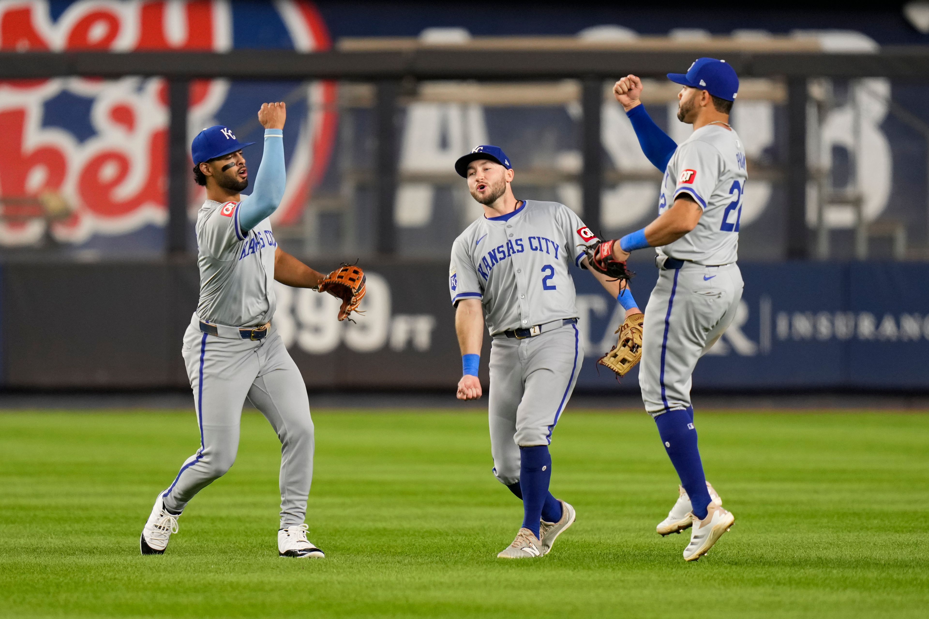 Kansas City Royals outfielders MJ Melendez, left, Garrett Hampson and Tommy Pham celebrate after a baseball game against the New York Yankees at Yankee Stadium Tuesday, Sept. 10, 2024, in New York. (AP Photo/Seth Wenig)