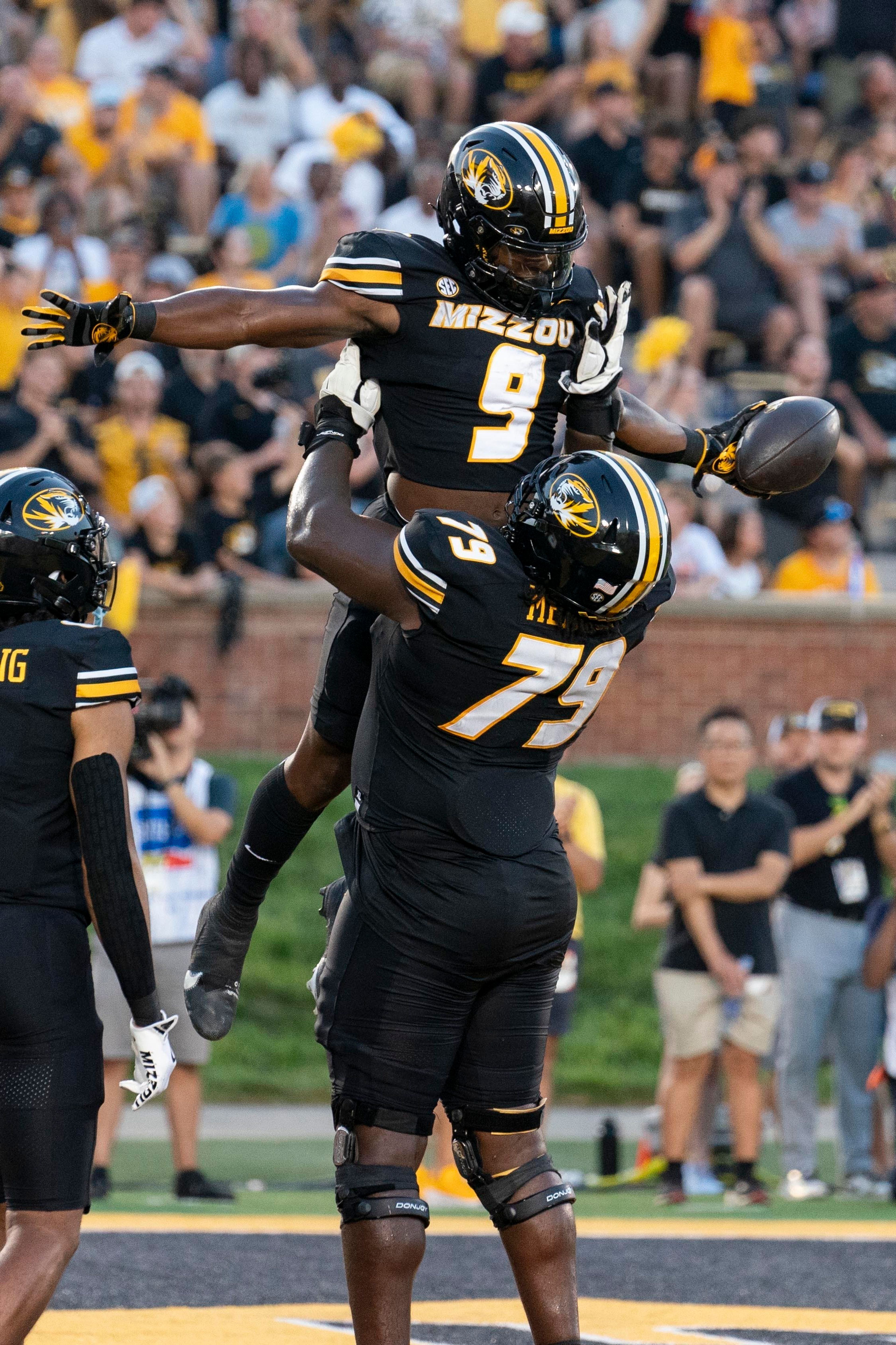 Missouri running back Marcus Carroll (9) is lifted in the air by teammate Armand Membou (79) after Carroll scored a touchdown during the first quarter of an NCAA college football game against Murray State, Thursday, Aug. 29, 2024, in Columbia, Mo. (AP Photo/L.G. Patterson)