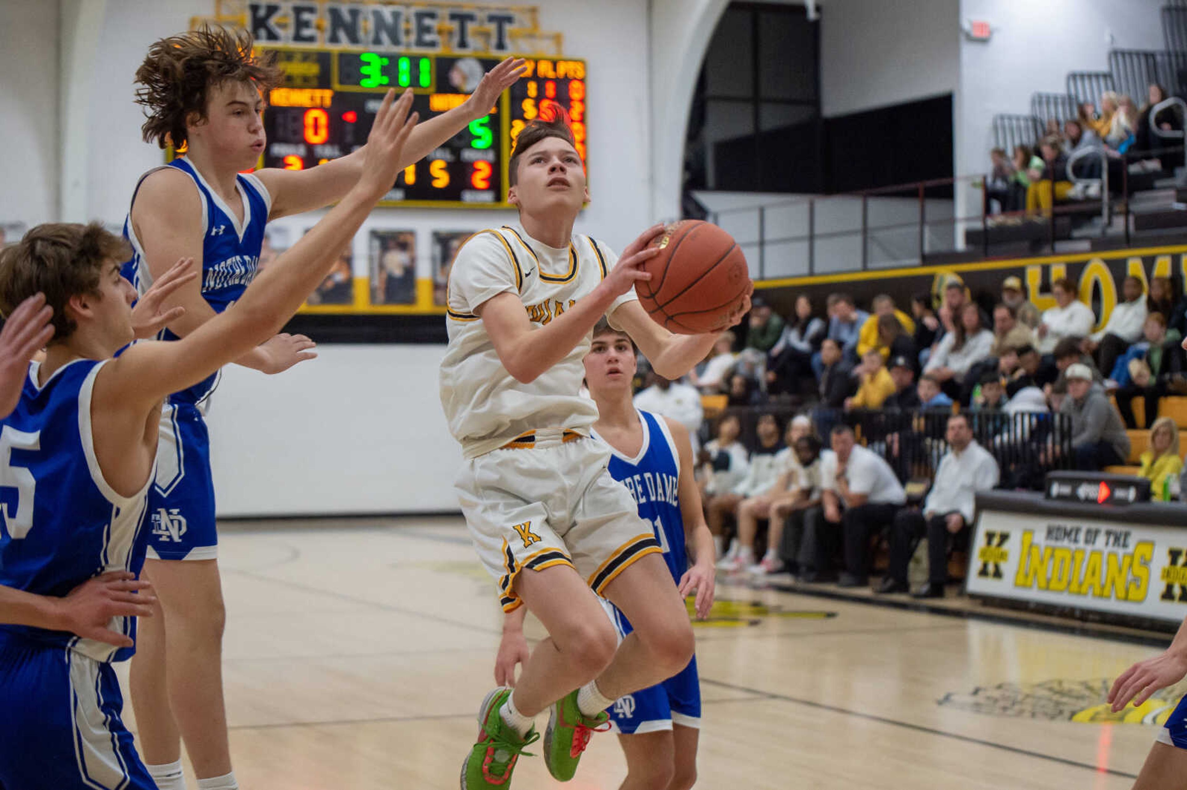 Kennett's Dyson Watson (3) maneuvers around Notre Dame defenders for a layup Friday, Jan. 12.