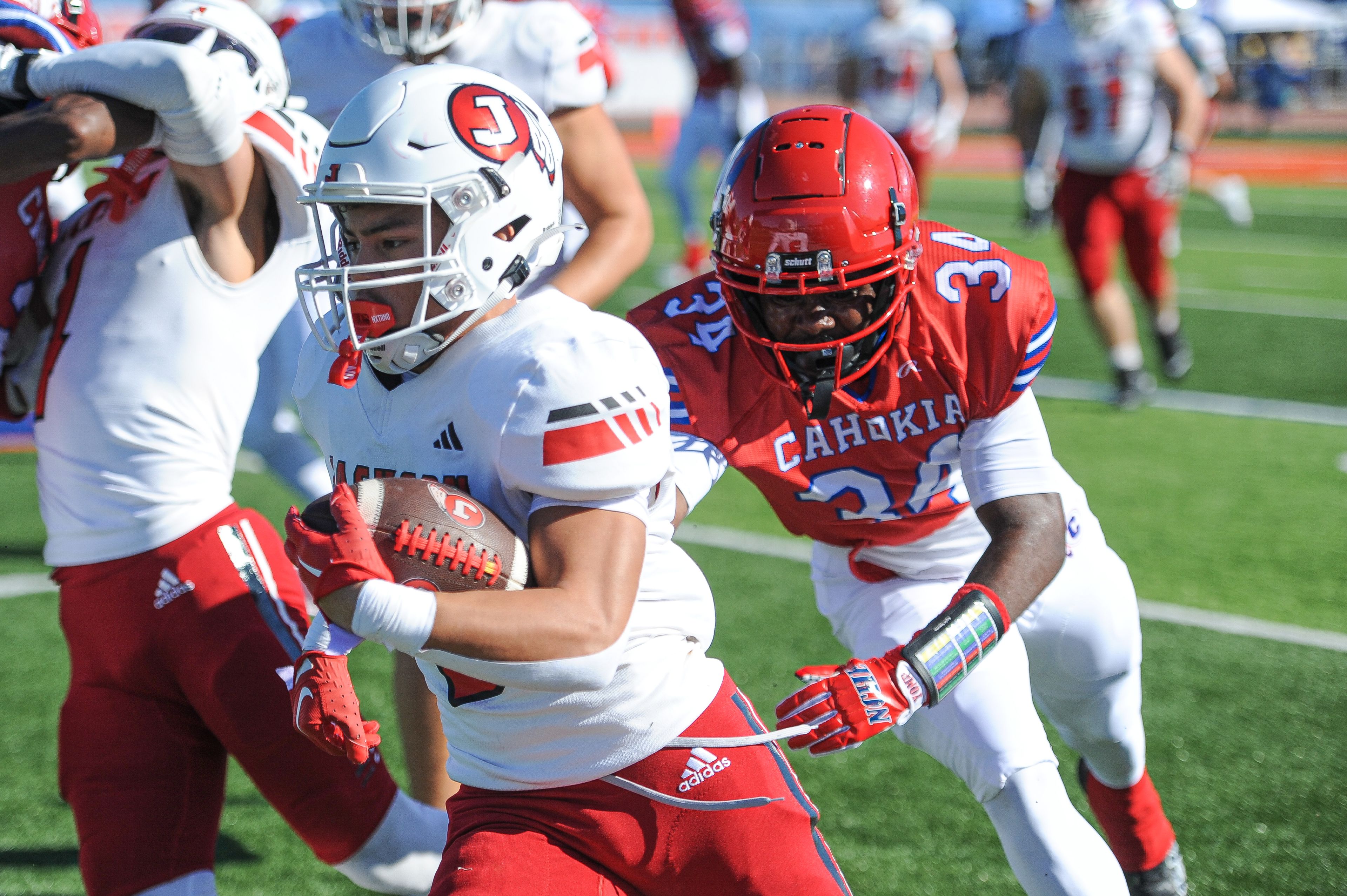 Jackson's Jaylon Hampton (left) rushes upfield during a Saturday, September 7, 2024 game between the Jackson Indians and the Cahokia Comanches at East St. Louis Senior High School in East St. Louis, Ill. Jackson defeated Cahokia, 49-26.