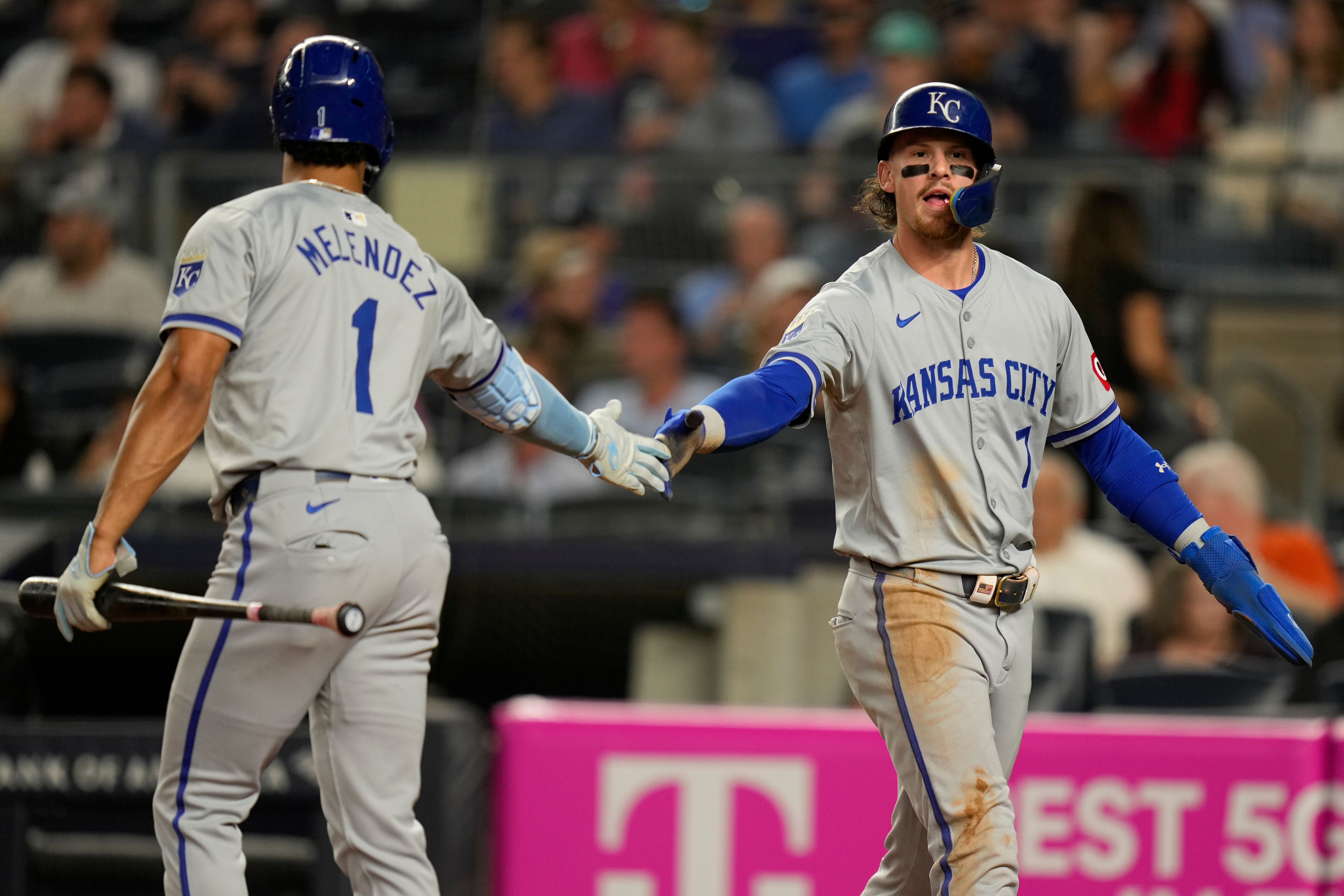 Kansas City Royals' Bobby Witt Jr., right, celebrates with MJ Melendez (1) after scoring on a single hit by Salvador Perez during the third inning of a baseball game at Yankee Stadium, Tuesday, Sept. 10, 2024, in New York. (AP Photo/Seth Wenig)