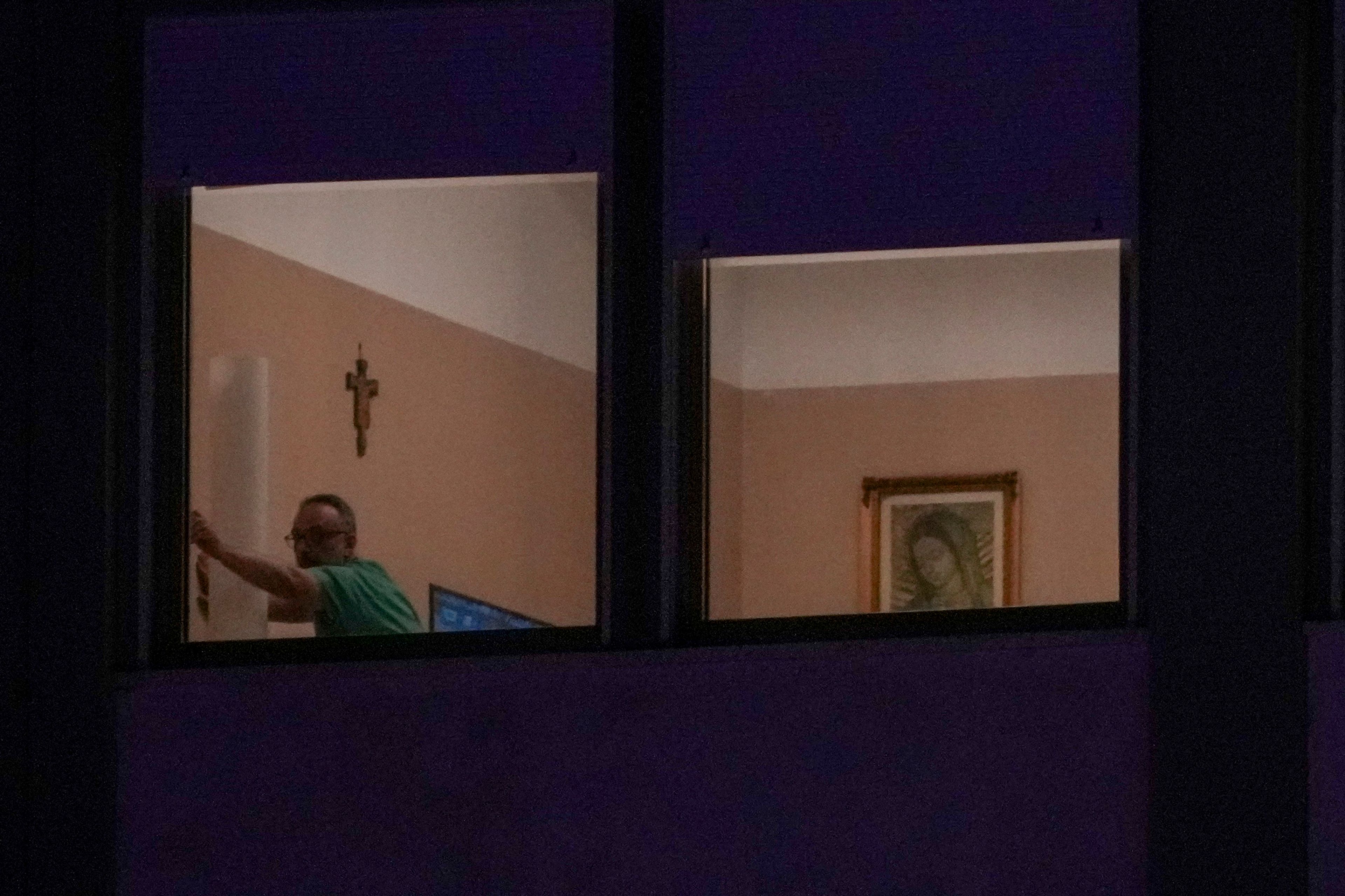 A man closes a window in the ward where Pope Francis is hospitalized at the Agostino Gemelli Polyclinic, in Rome, Italy, Sunday, March 2, 2025. (AP Photo/Andrew Medichini)