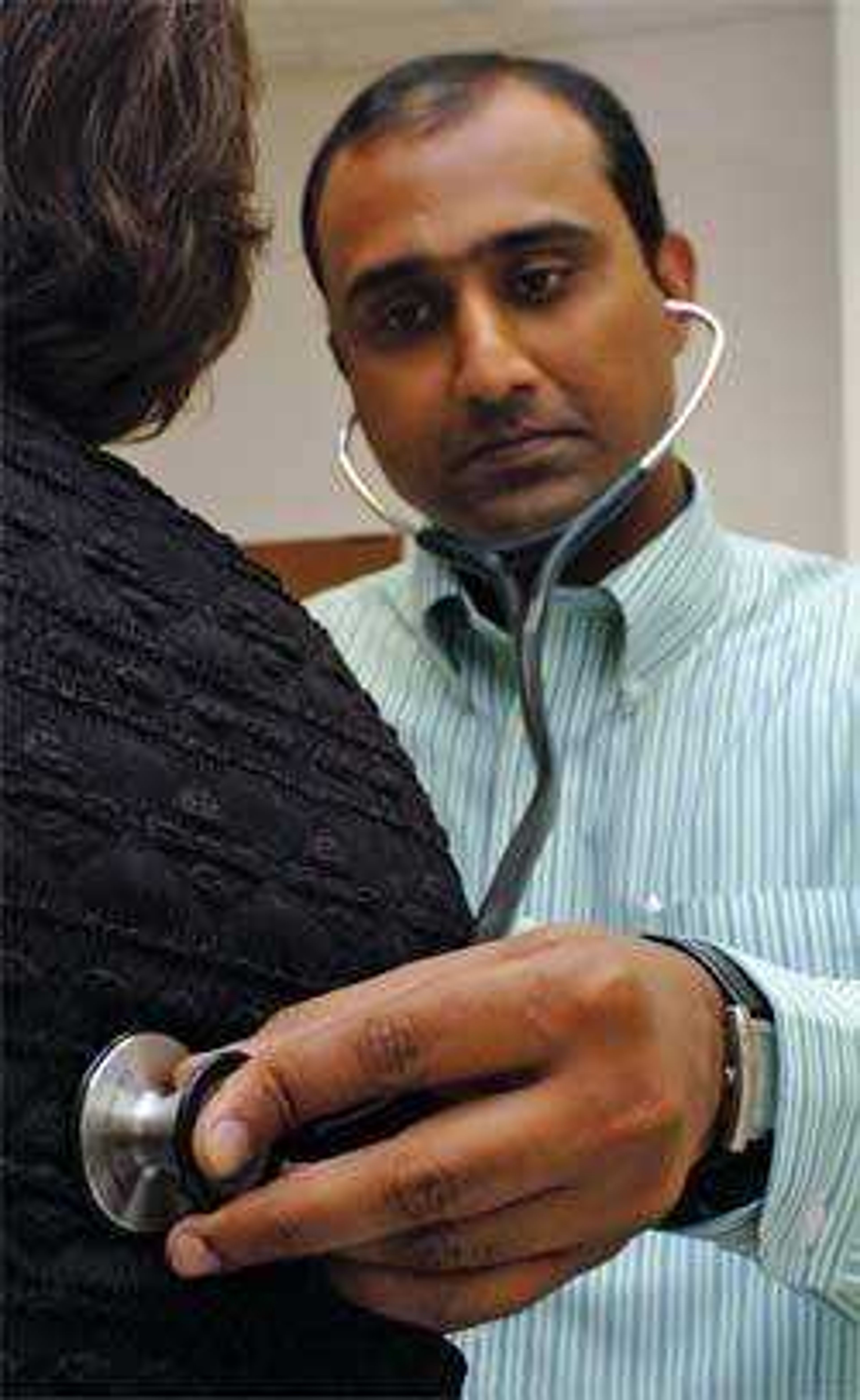 Mohammad Safdar, M.D. at the Missouri Delta Medical Center's Express Care, assesses a patient Monday afternoon.