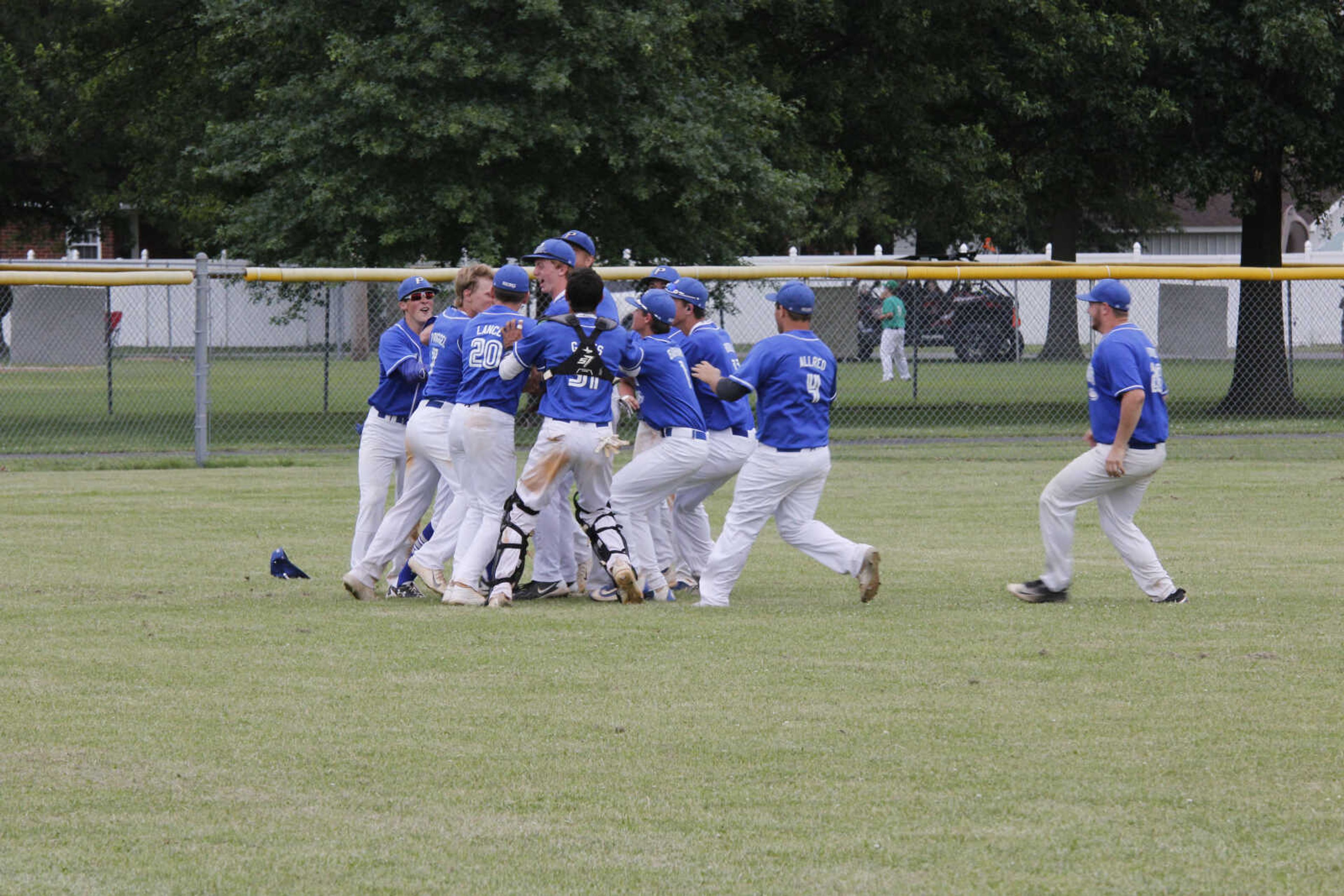 Diving catch from left, fielder Ryan Priggel, robbed Twin Rivers' Zac Hardin of a potential game-tying hit and sending Portageville on to the quarterfinals with a 6-4 win. Above, the whole roster of players game to congratulate Priggel for his efforts. -Scott Seal, staff