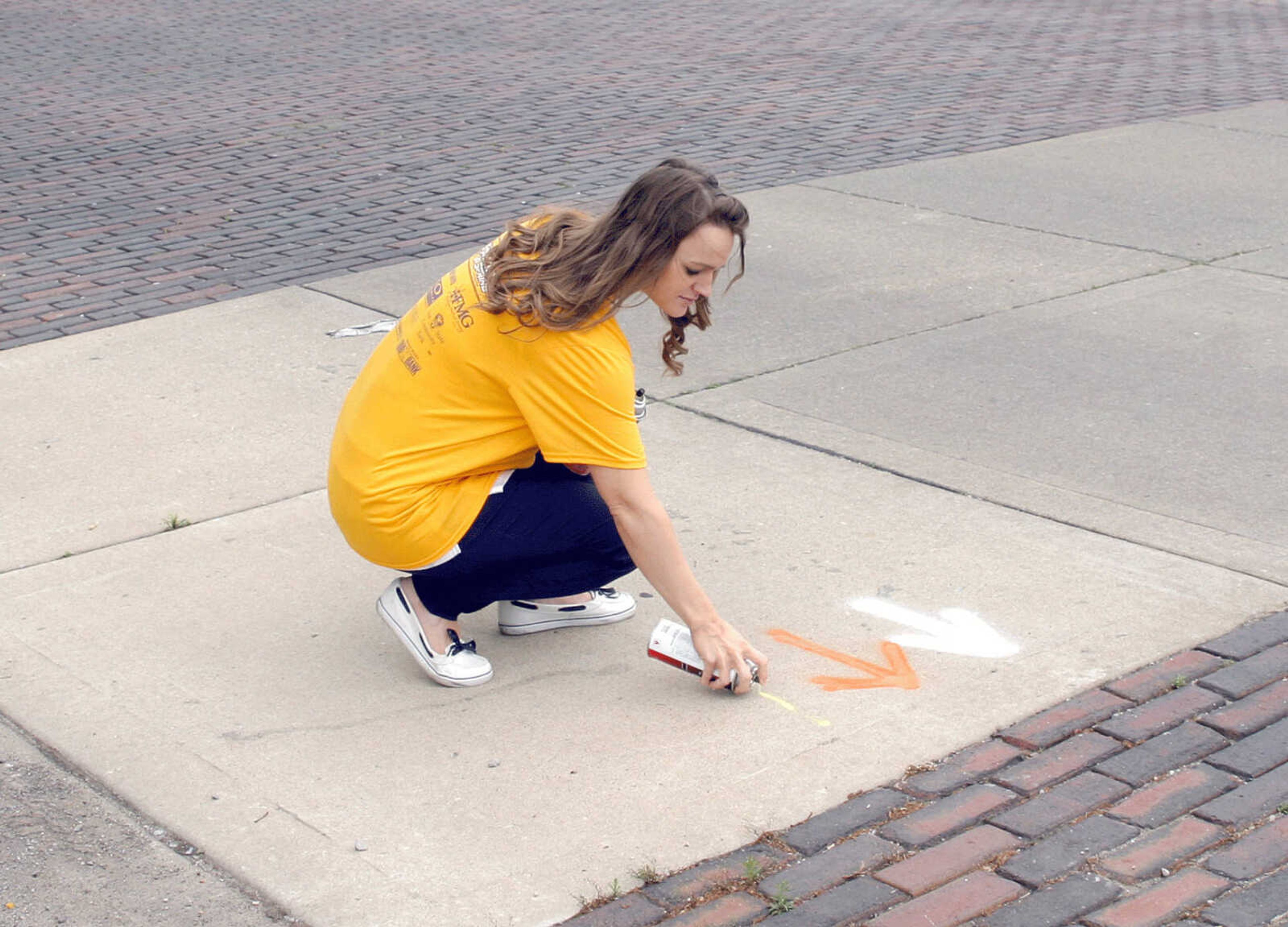 Cassidy Obermark, Lions Club member and volunteer for Sprockets in Spring, paints guide markers for cyclists' routes Tuesday afternoon on New Madrid Street. The ride starts at 8 a.m. Saturday at the Sikeston Depot Museum.
Rose Mary Nabors, Staff