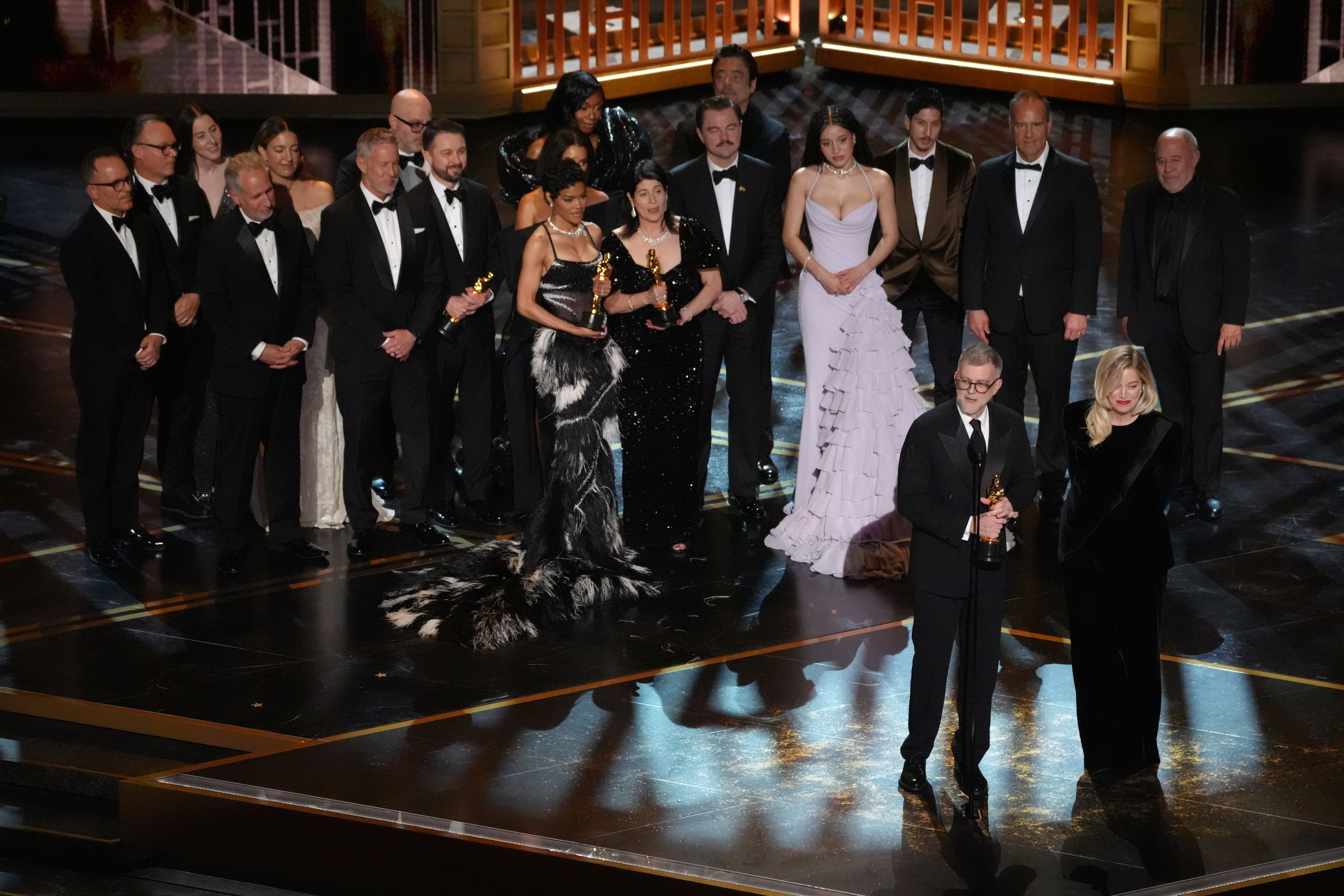Paul Thomas Anderson, left center, Sara Murphy, right center, and the team from "One Battle After Another" accept the award for best picture during the Oscars on Sunday, March 15, 2026, at the Dolby Theatre in Los Angeles. (AP Photo/Chris Pizzello)